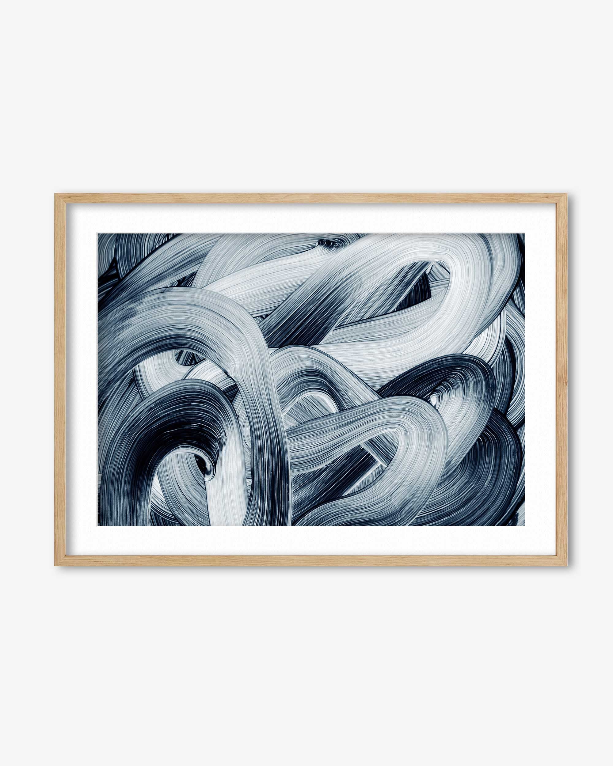 Framed abstract art print with swirling blue and white patterns on a white background