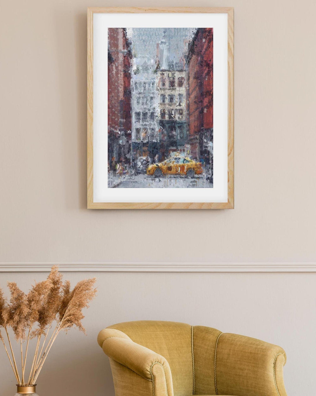 Framed artwork of a city street scene with a yellow taxi, placed above a yellow armchair.