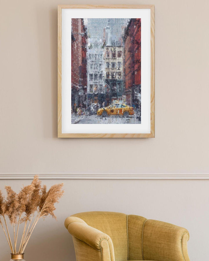 Framed artwork of a city street scene with a yellow taxi, placed above a yellow armchair.