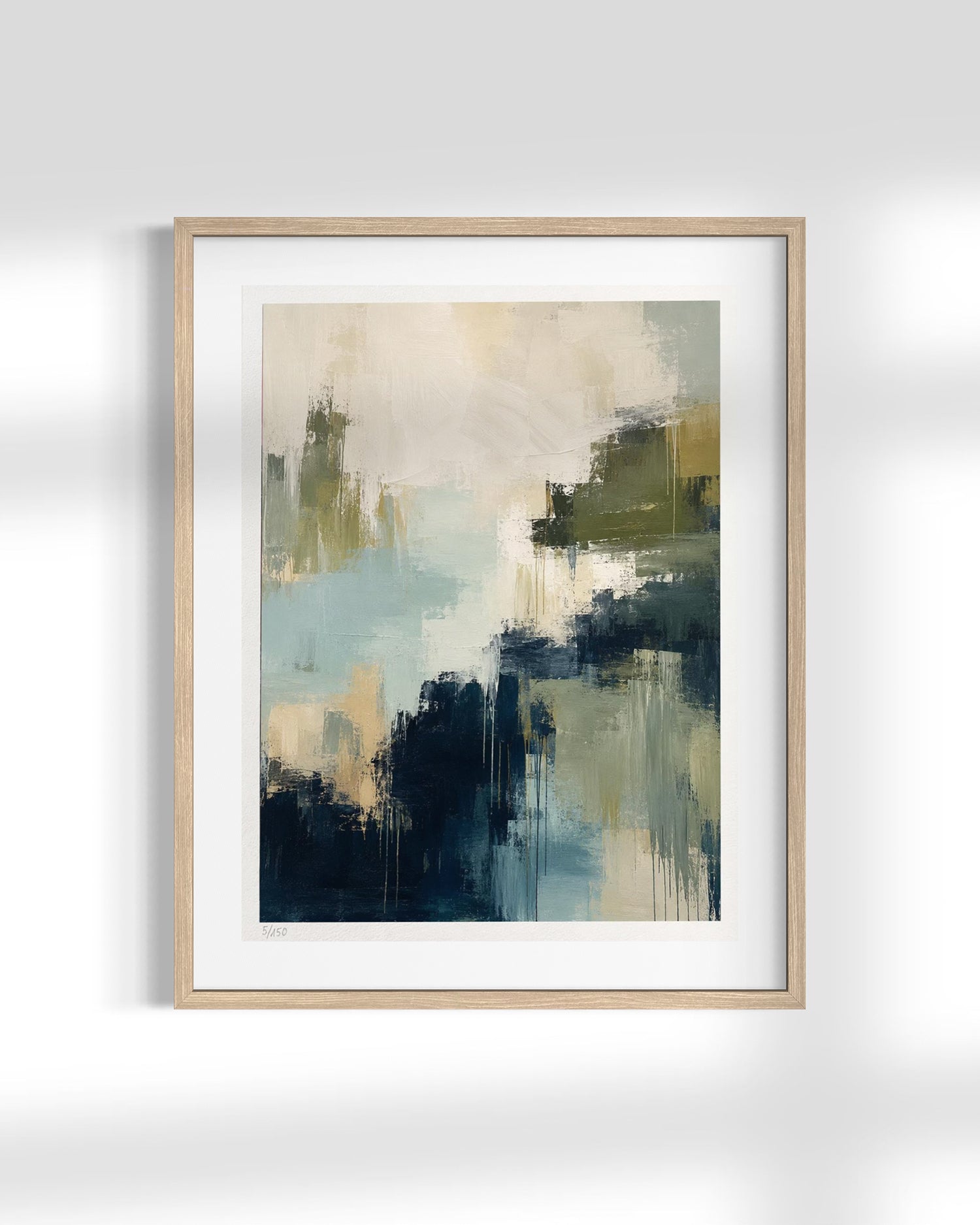 Framed abstract wall art print with soft brushstrokes in navy, teal, beige, and olive tones, shown in a light wood frame against a white wall.