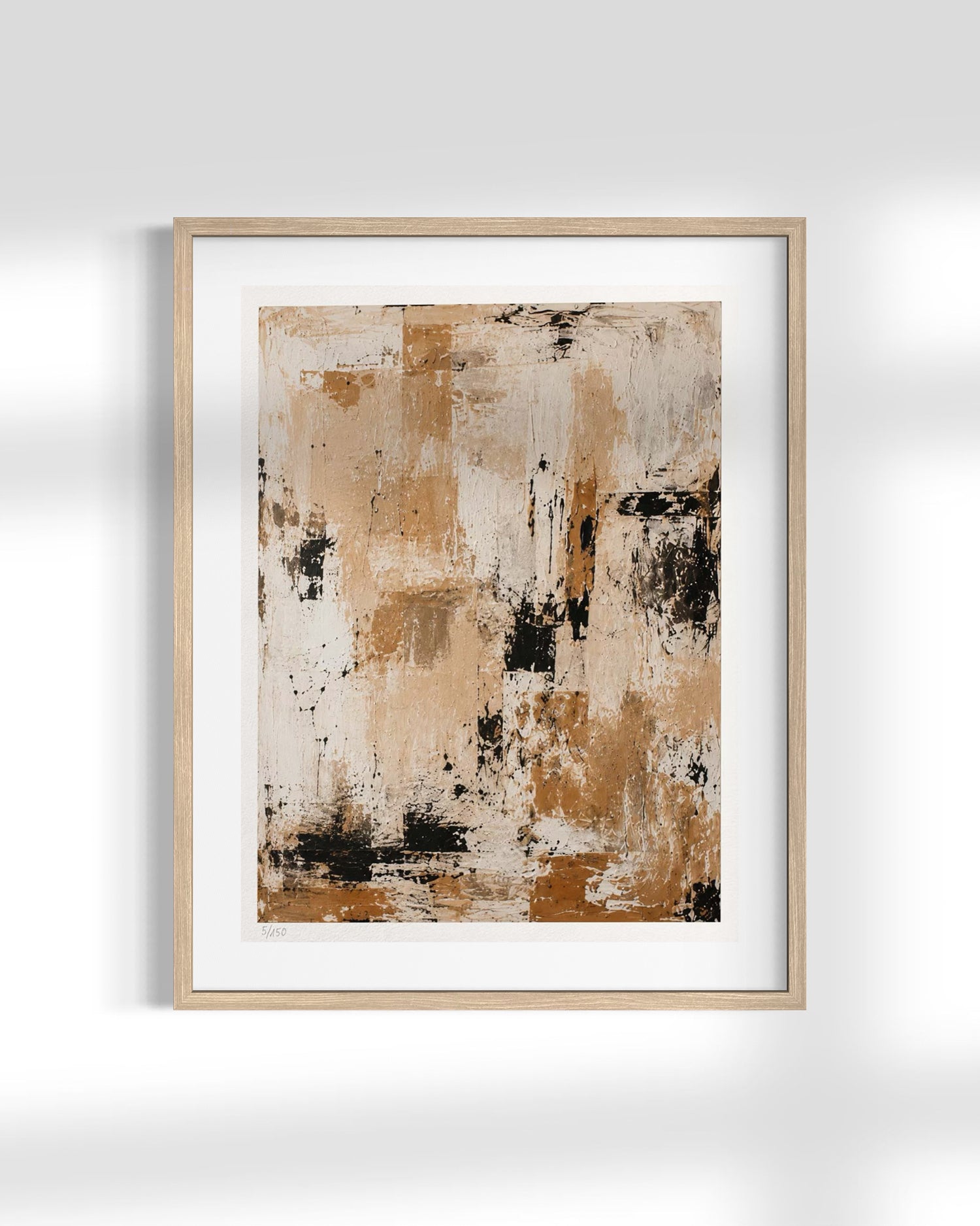 Framed abstract wall art print with a light wood frame and white mat, featuring textured beige, brown, cream, and black brushstrokes, shown hanging on a light gray wall.