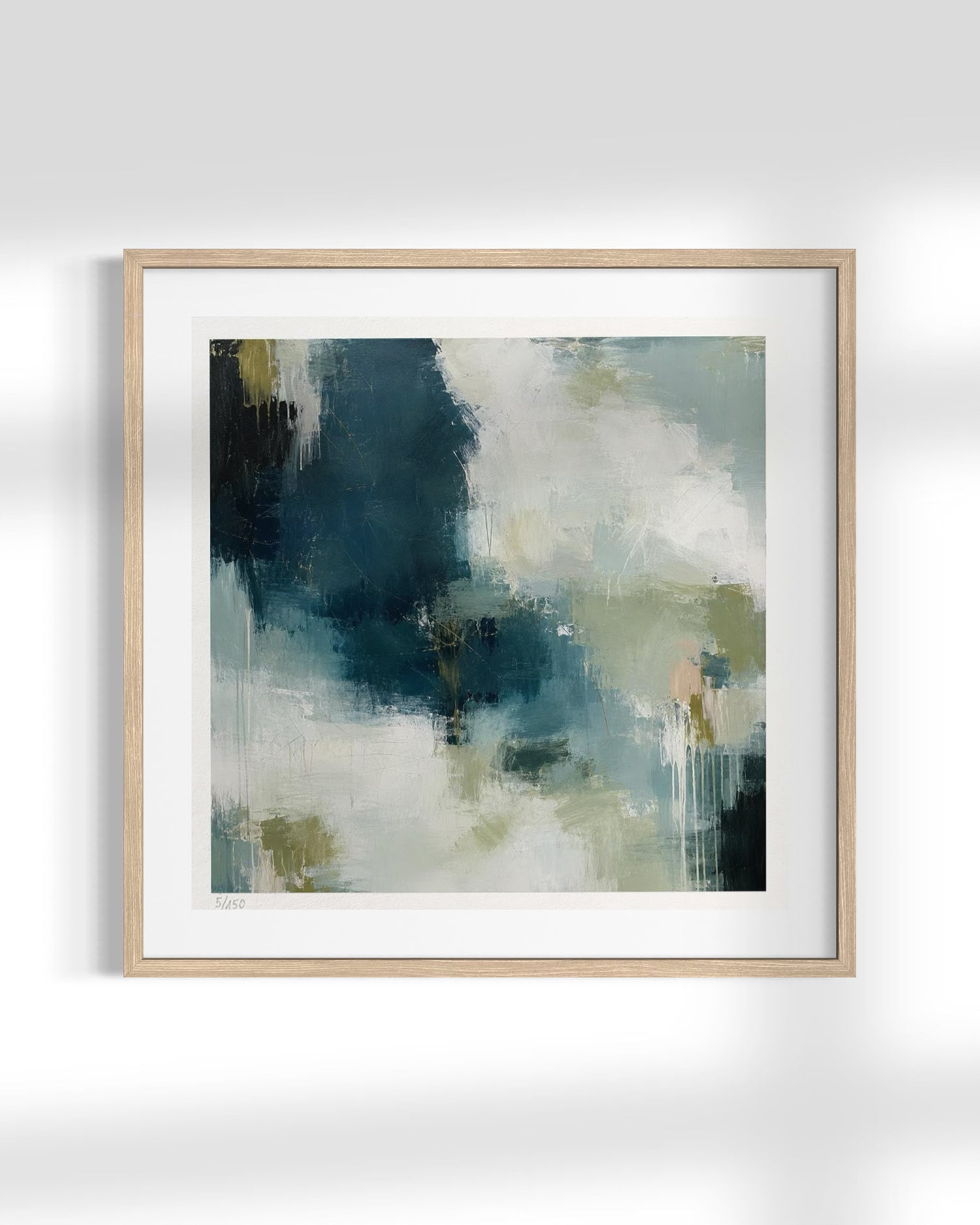 Framed abstract wall art featuring a textured painting with dark teal, slate blue, cream, and soft olive-green brushstrokes, presented in a light natural wood frame with a white mat against a clean white background.