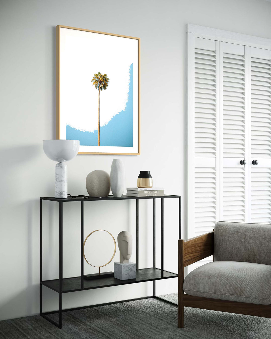 Modern living room with a console table, chair, and framed artwork of a palm tree.