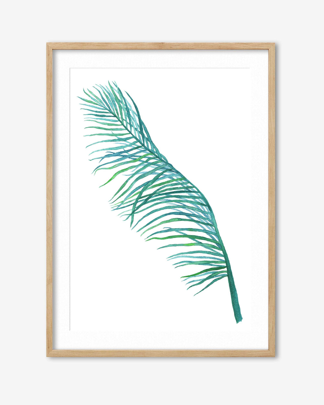 Framed artwork of a green palm leaf on a white background
