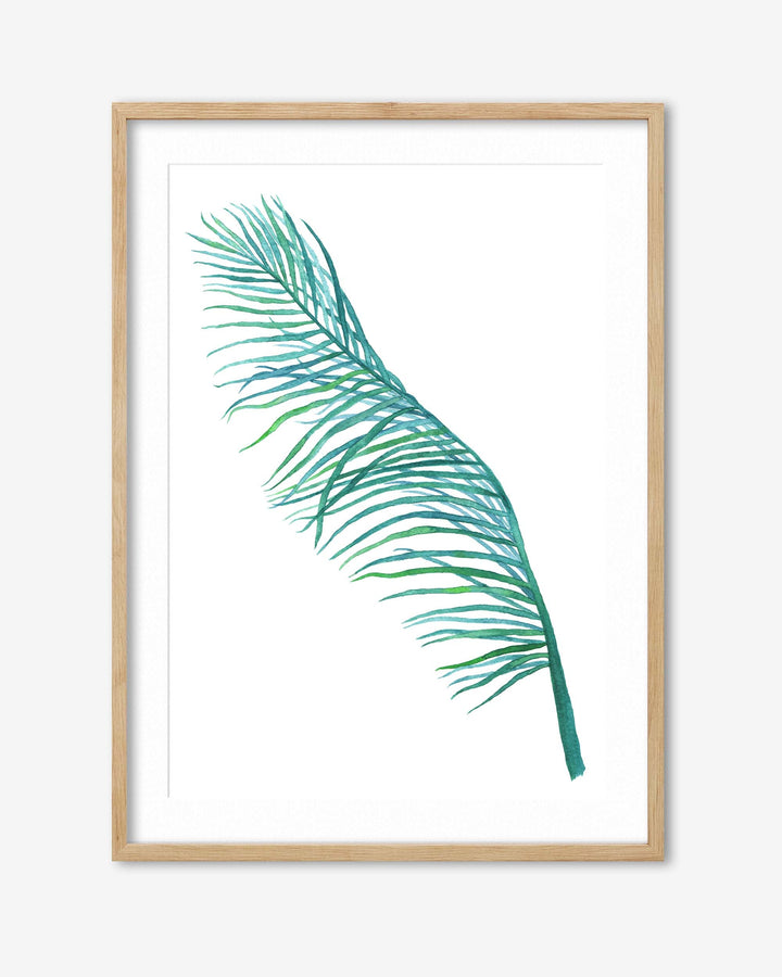 Framed artwork of a green palm leaf on a white background