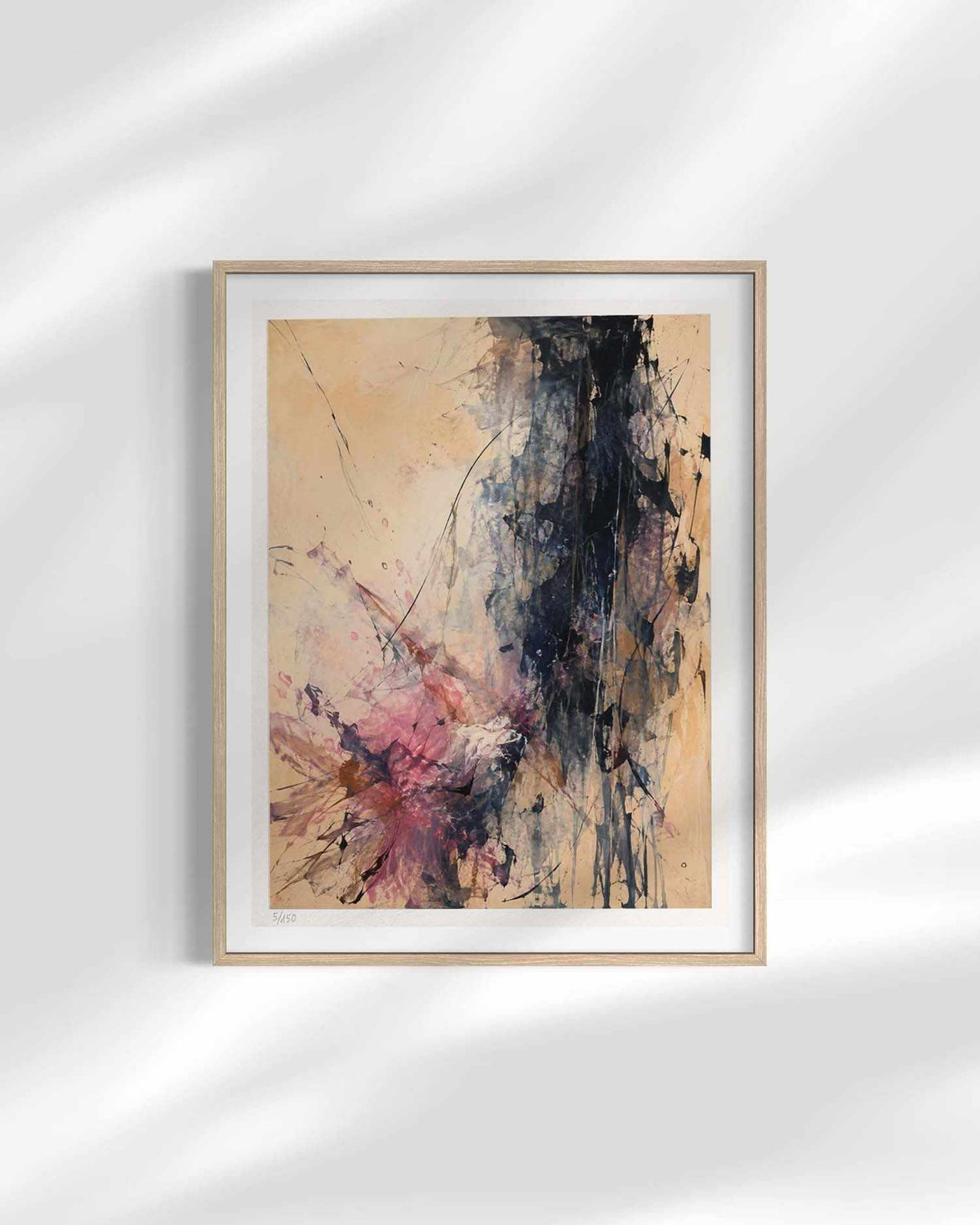 A framed abstract art print featuring a textured composition of beige, black, pink, and brown tones, displayed on a light gray wall with soft shadow overlays.