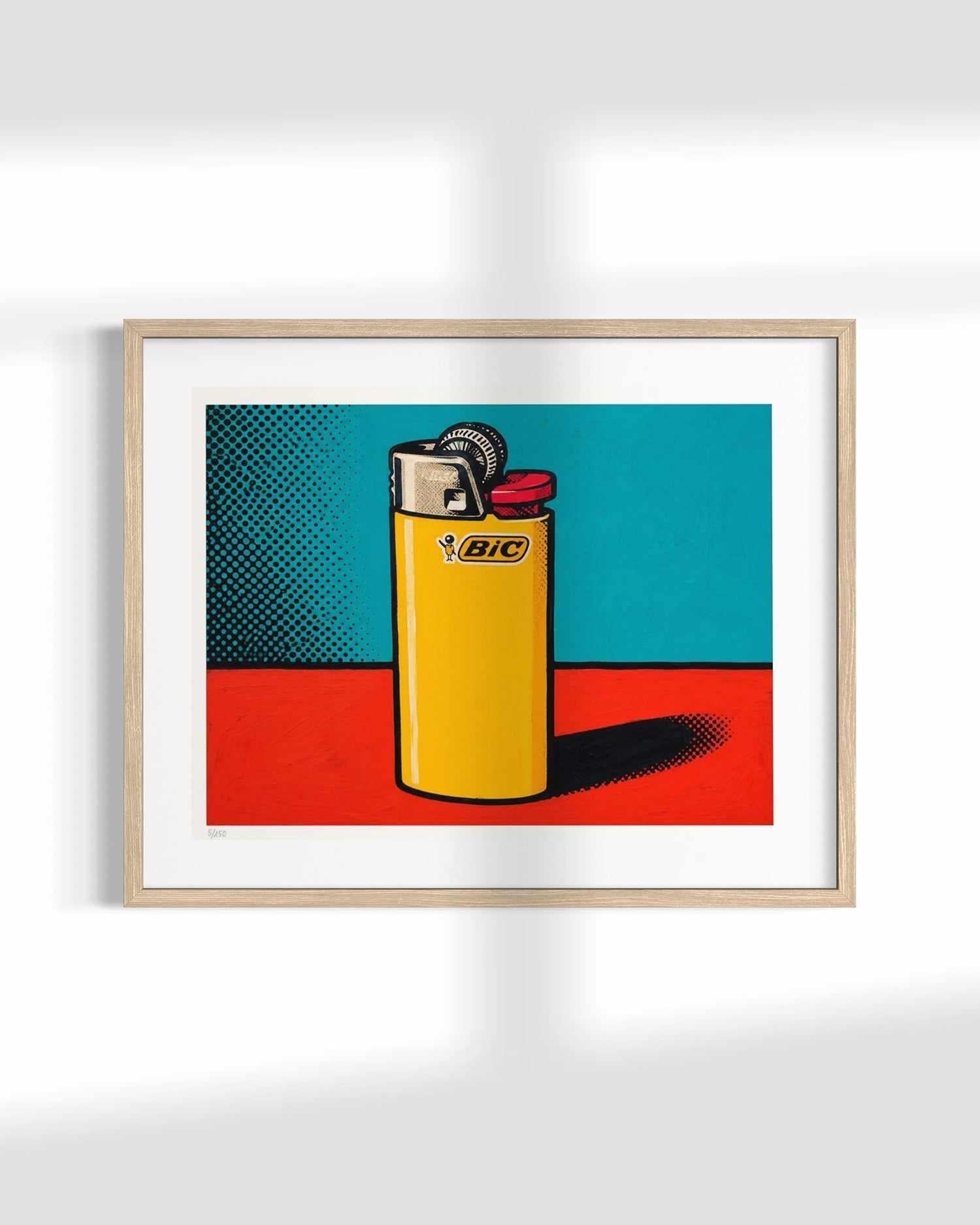 A framed pop-art print featuring a yellow BIC lighter on a red and teal background, displayed on a white wall with soft shadows.