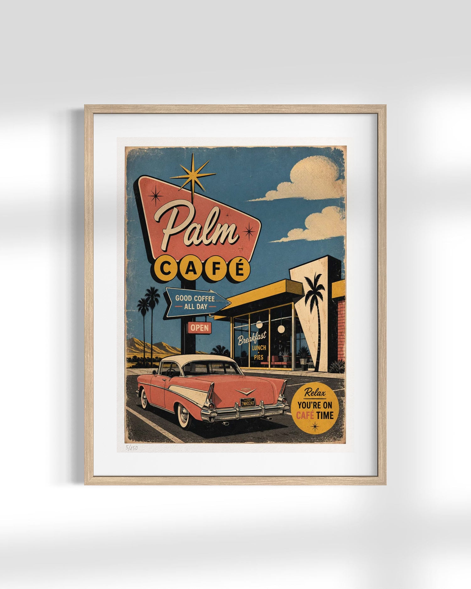 A framed retro-style art print of a vintage 'Palm Cafe' sign, featuring a pink classic car, a storefront, and a blue sky with clouds, displayed against a light gray wall.