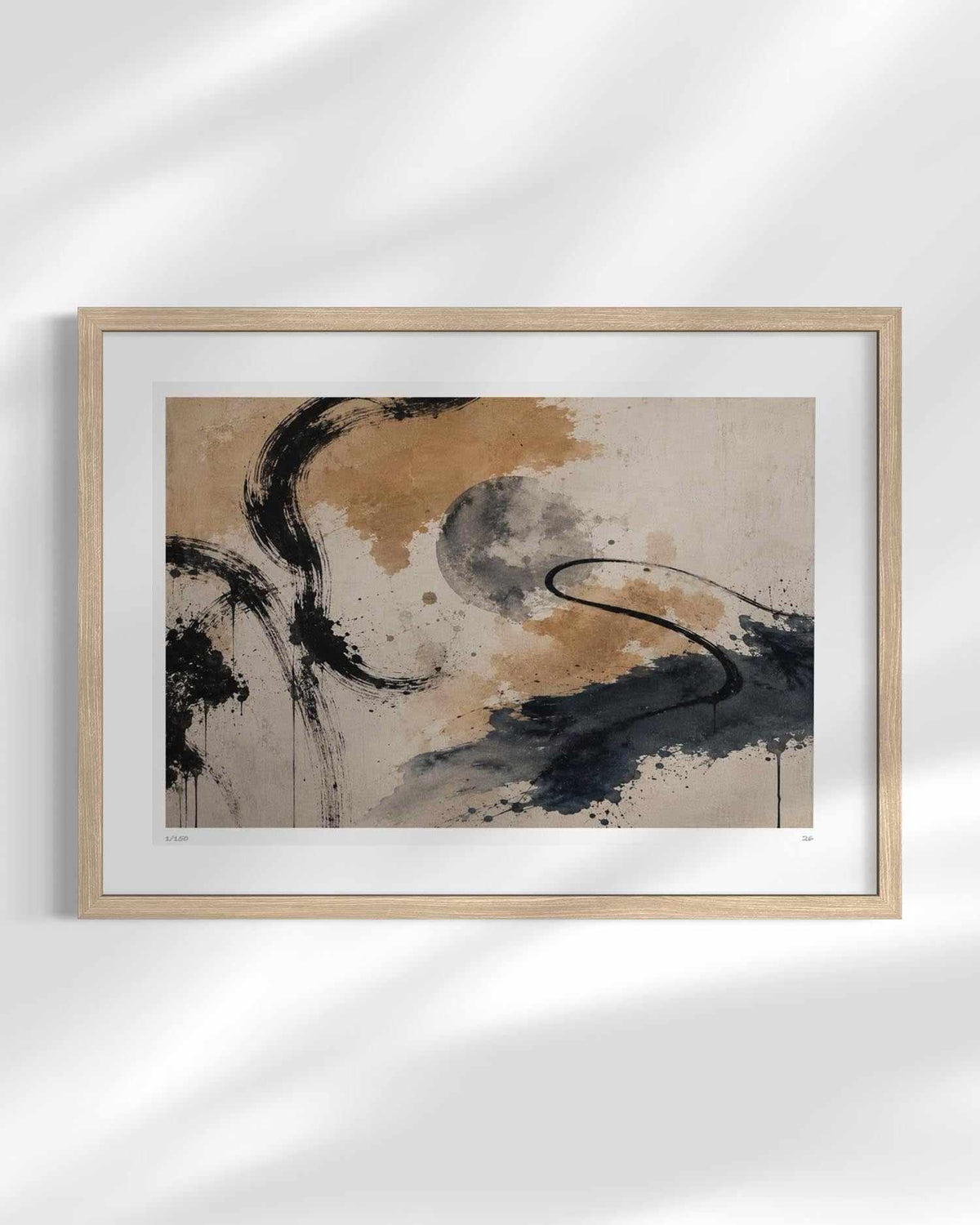 A framed abstract art print featuring black ink brushstrokes and splatters over a textured beige and brown background, housed in a light wood frame with a white mat, displayed against a white wall with soft shadow overlays.