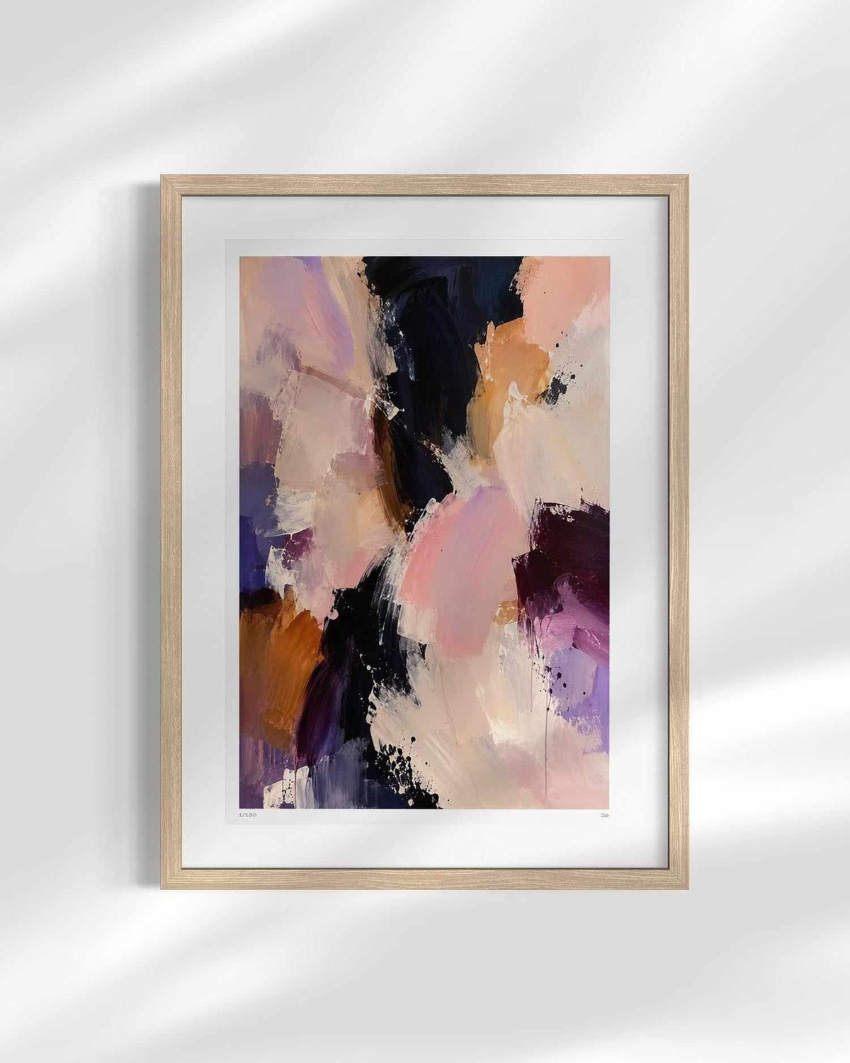 Framed abstract wall art print with soft brushstrokes in blush pink, lavender, peach, cream, and dark navy, shown in a light wood frame against a white wall with soft shadow overlays.