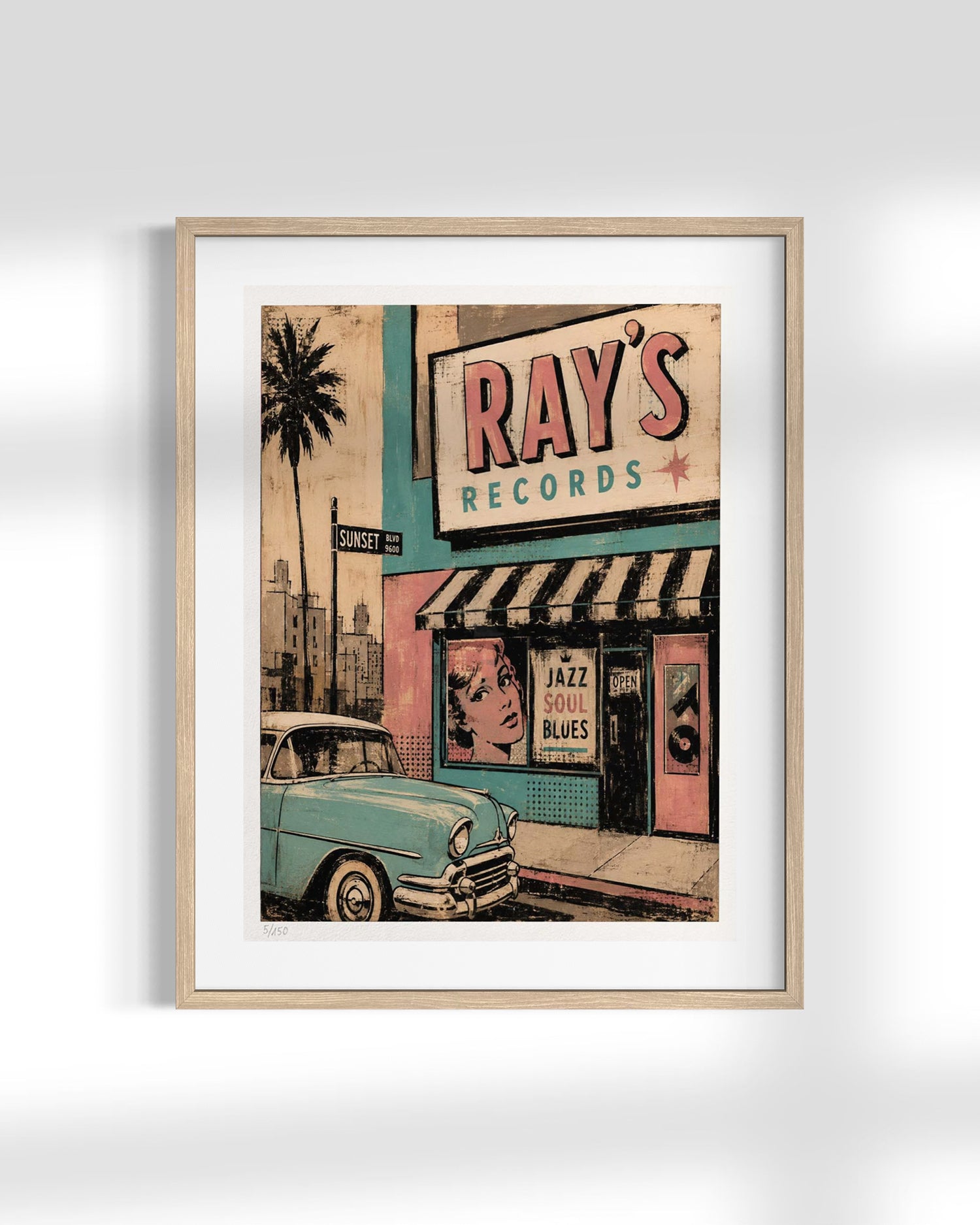 A framed vintage-style art print depicting a retro street scene with a light blue classic car, a palm tree, and a storefront sign reading 'RAY'S RECORDS' in pink and teal, shown against a clean white background.