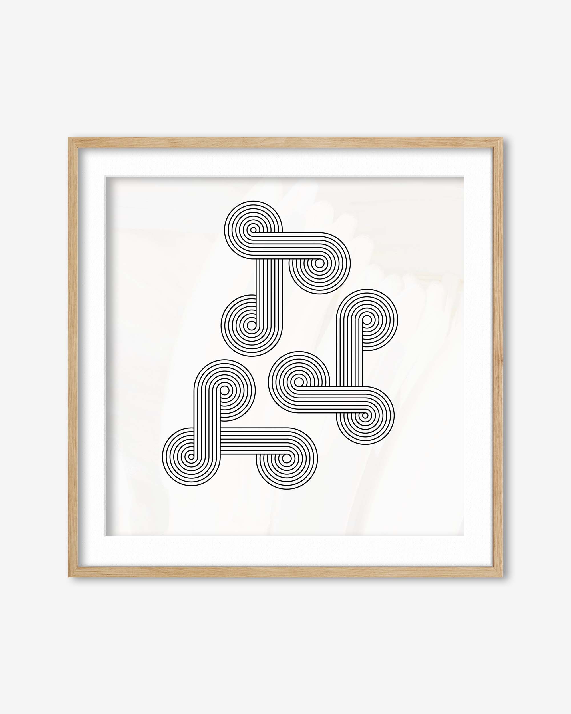Framed abstract art print with interlocking circular patterns on a white background