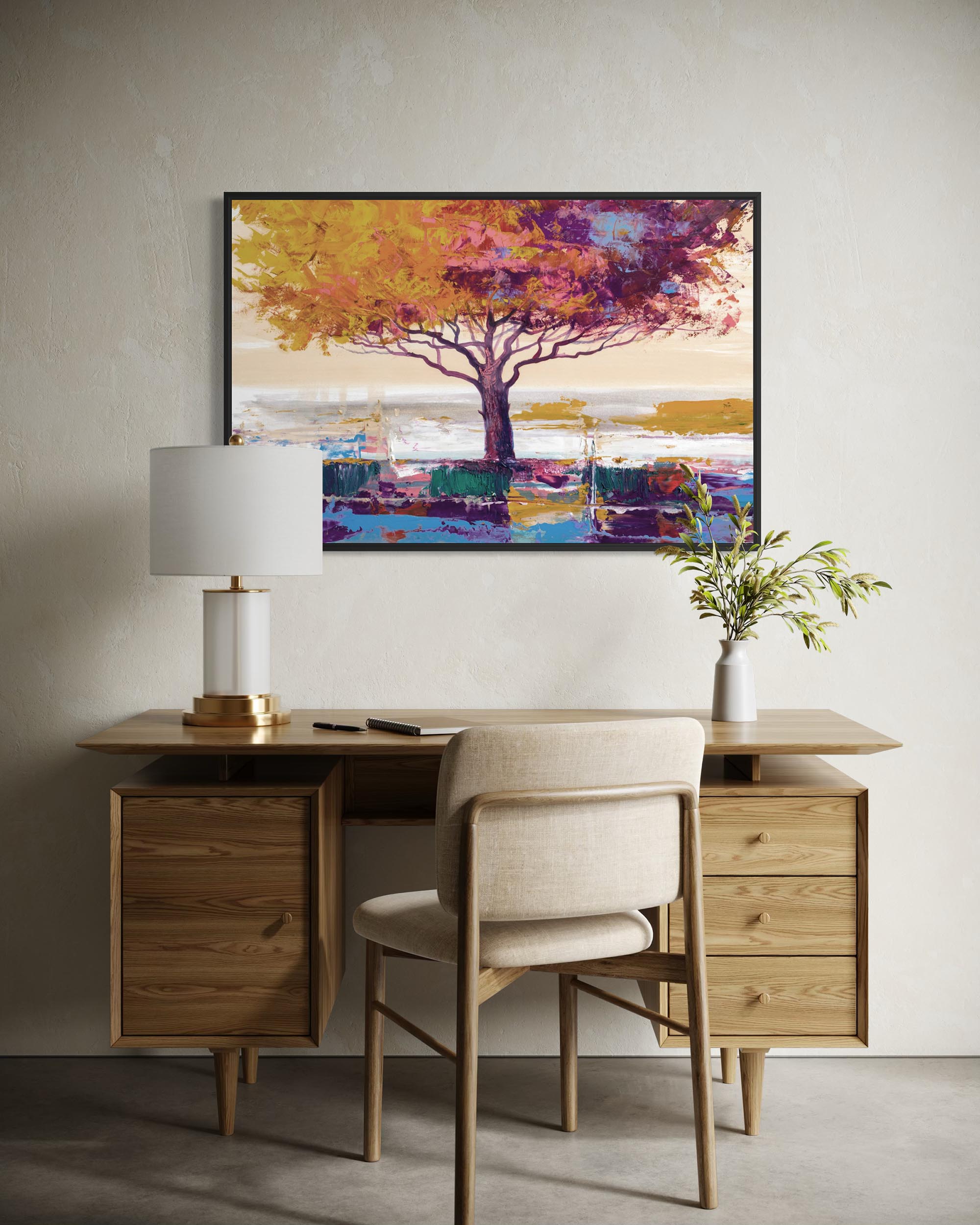 Wooden desk with chair, lamp, and decorative painting in a room.