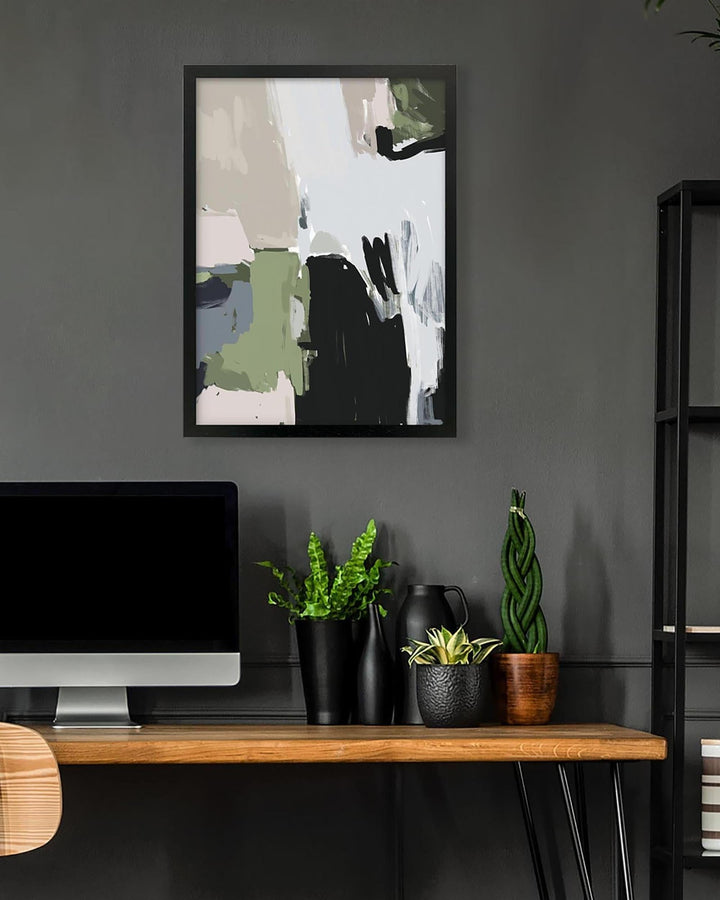 Modern office setup with abstract art, plants, and a computer on a wooden desk.