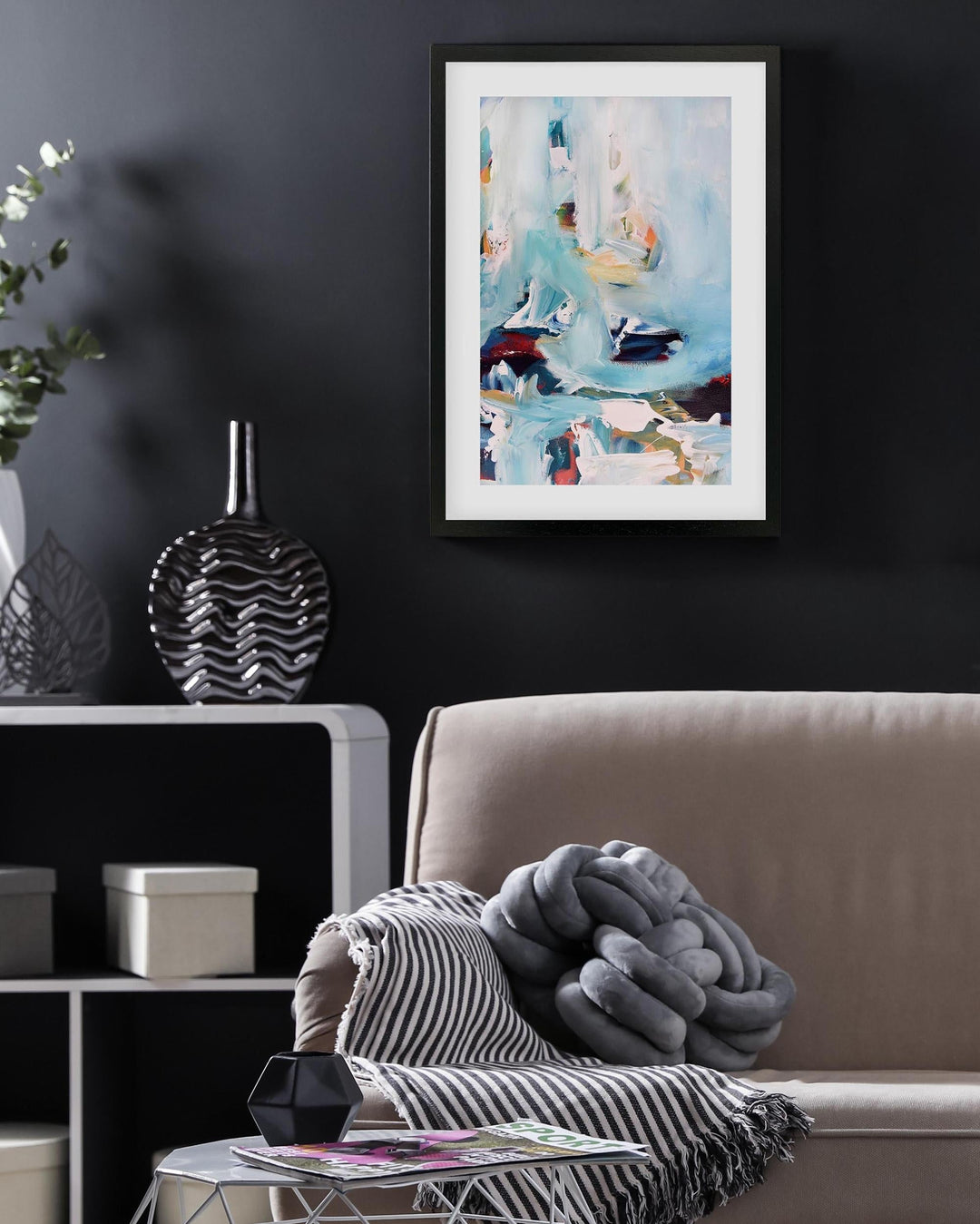 Living room with a sofa, coffee table, and wall art