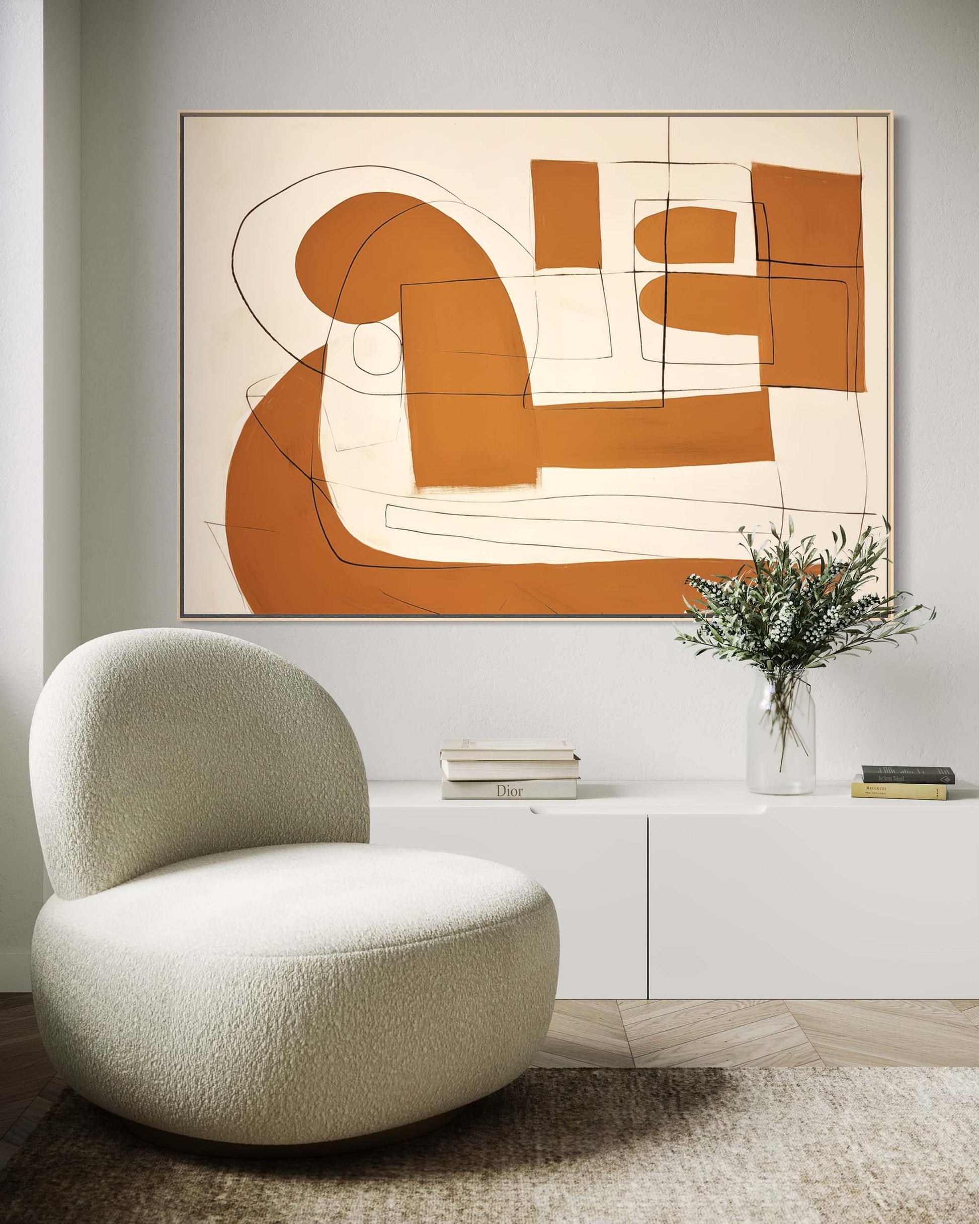 Modern living room with a beige chair, abstract painting, and decorative items.