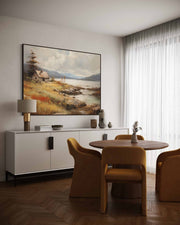 Dining room with a round table and chairs, white sideboard, and landscape painting on the wall.