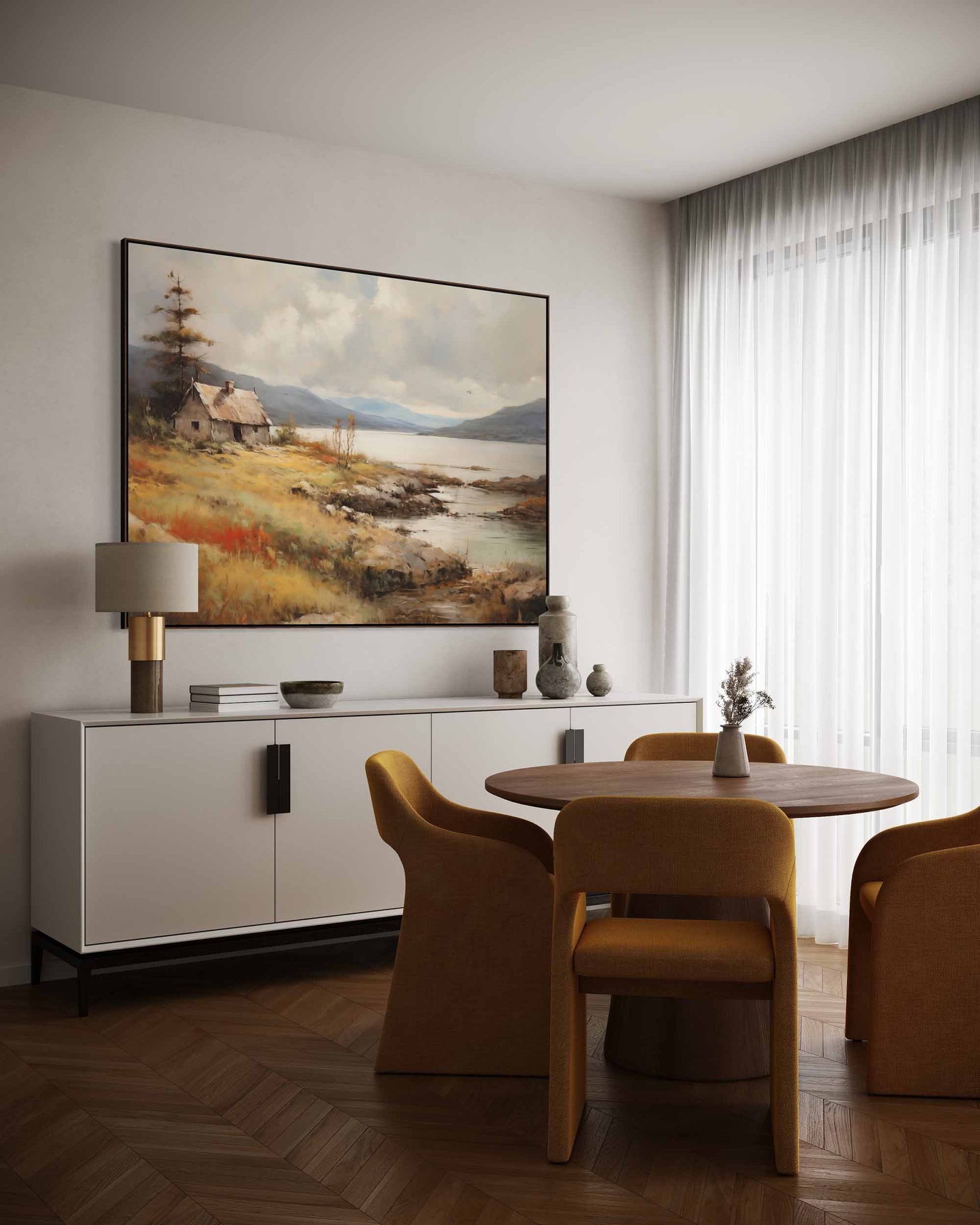 Dining room with a round table and chairs, white sideboard, and landscape painting on the wall.