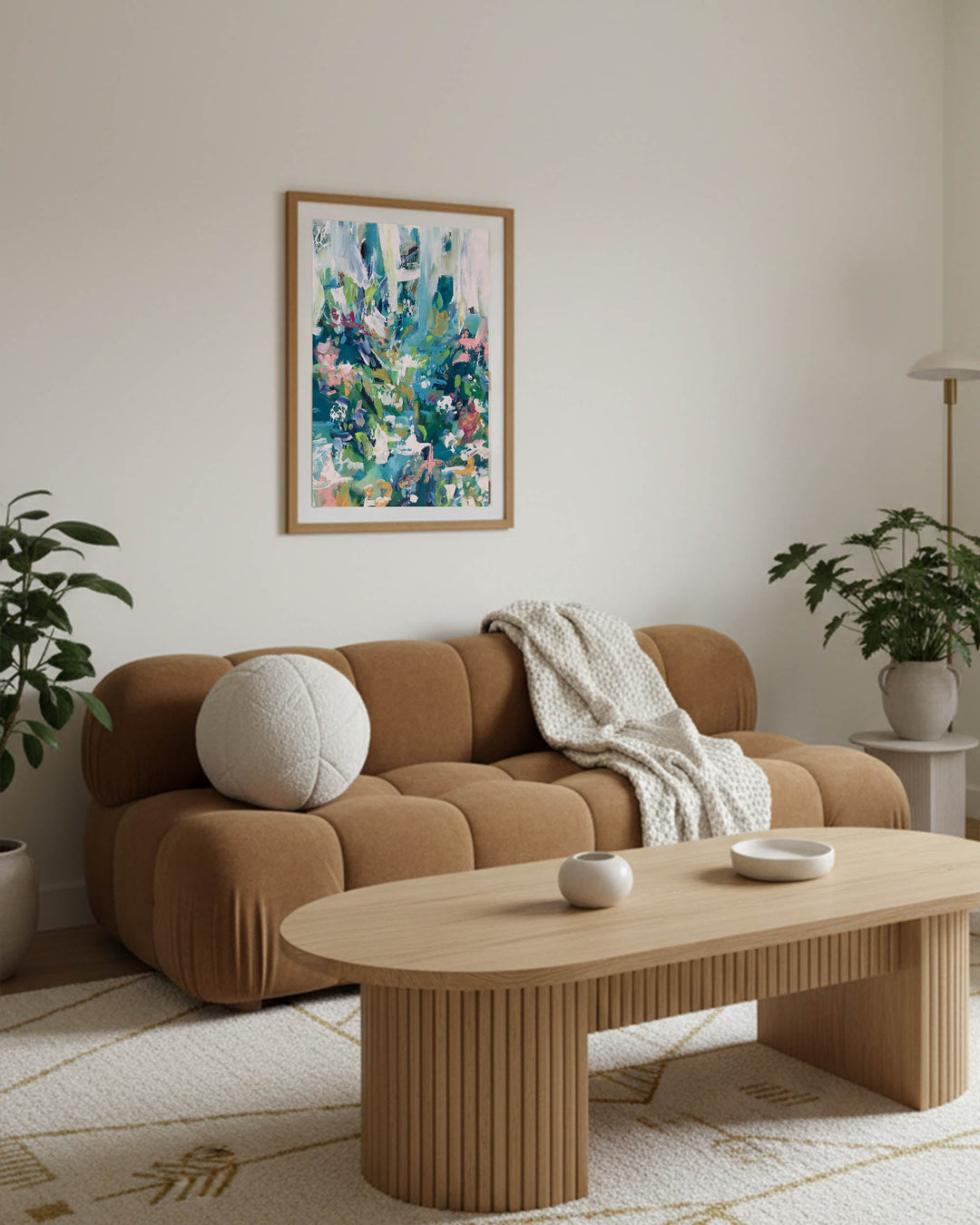 large modern scandinavian living room in apartment with modern colourful abstract wall art framed above the sofa, featuring oak coffee table