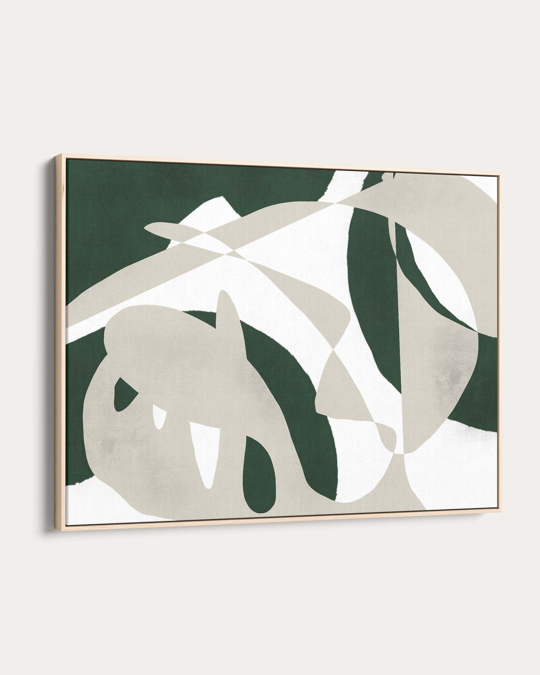 Framed artwork with green and beige abstract leaf design on a white wall