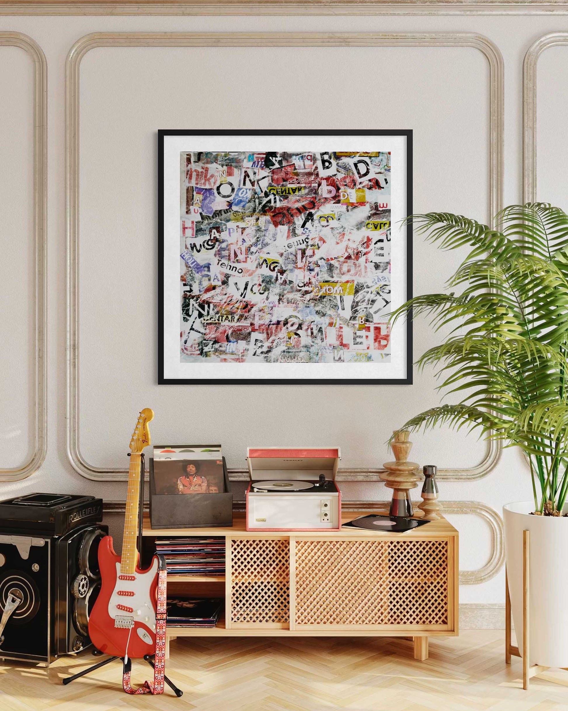 Framed collage art above a wooden console table with decorative items in a room.