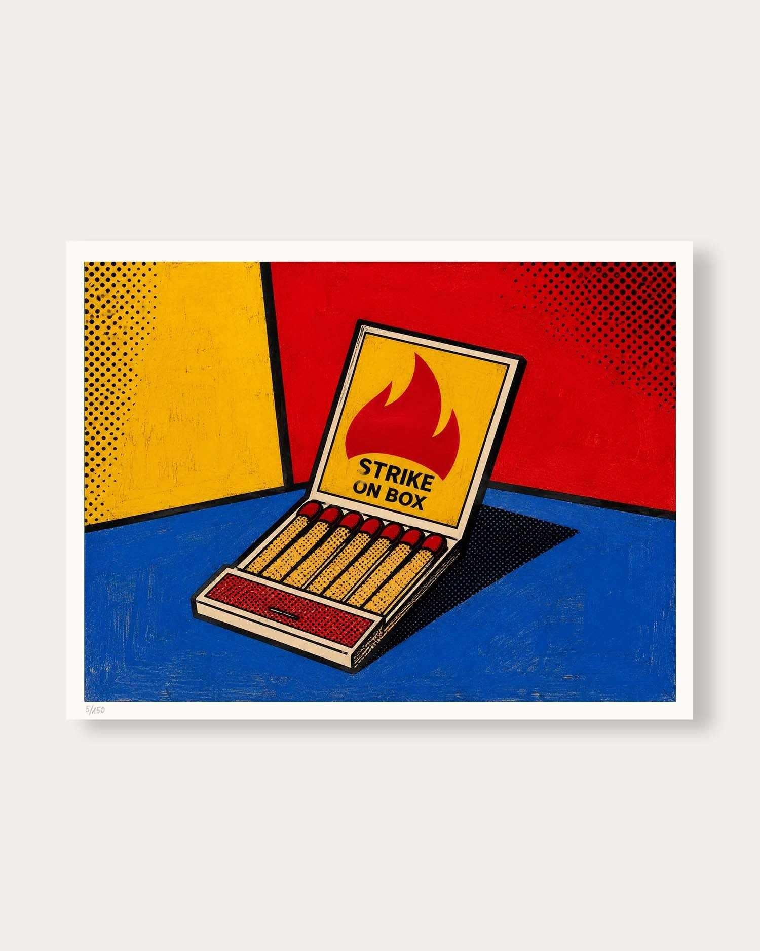 A pop art style print of an open matchbox with the words 'STRIKE UN BOX' and a flame graphic, set against a bold red, yellow, and blue background, shown with a white border on a light gray backdrop.