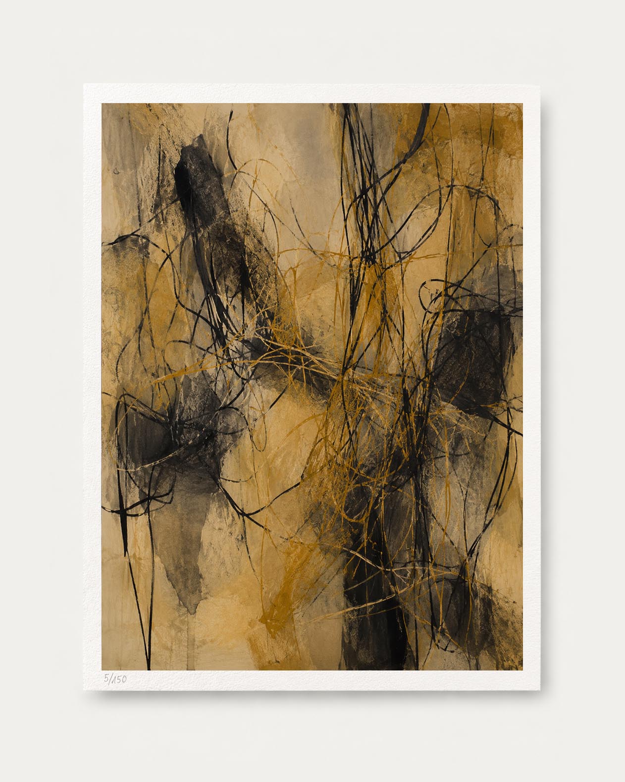 An abstract art print featuring expressive black and ochre yellow brushstrokes on a textured beige background, presented with a white border on a light gray wall.