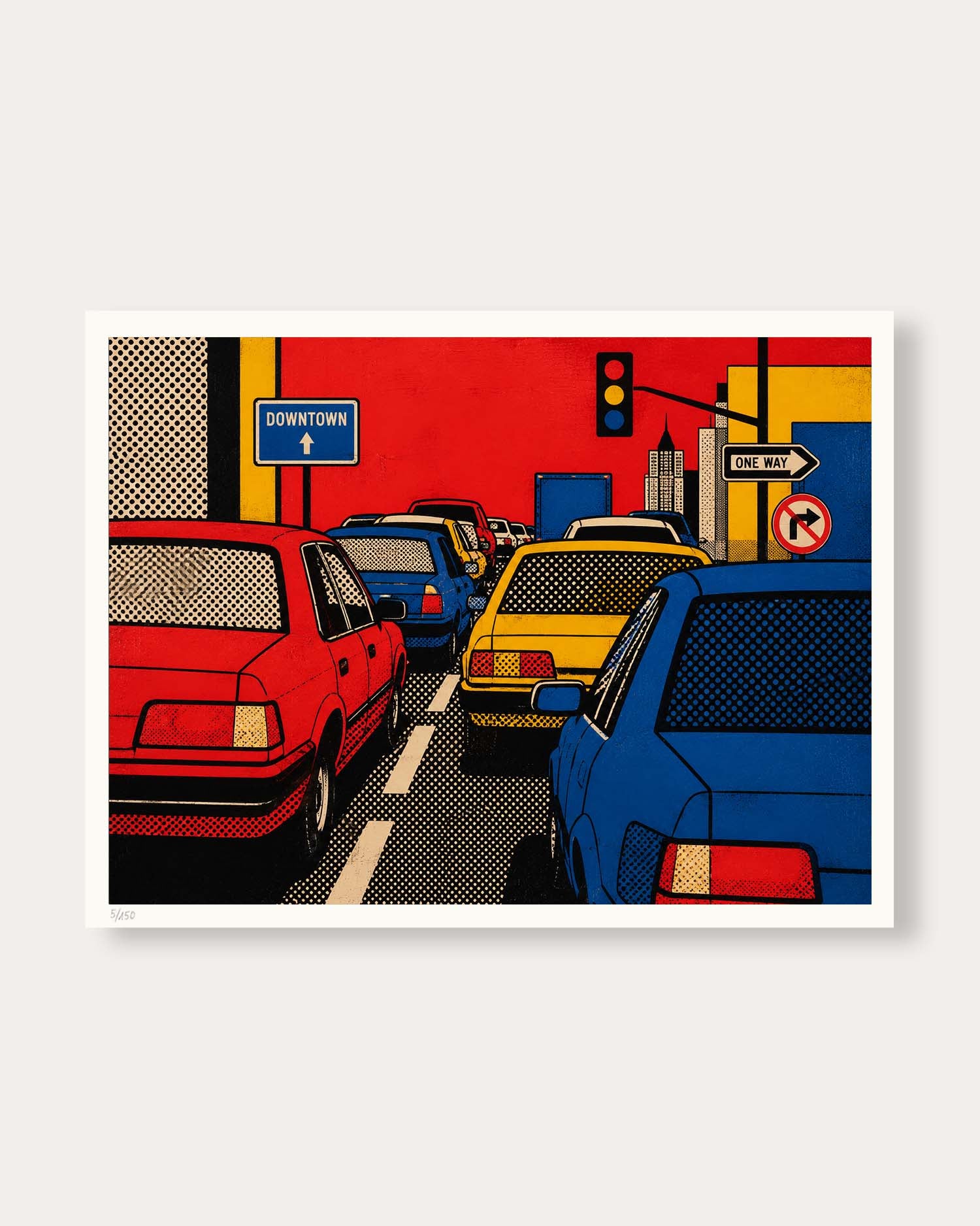 A framed pop art print depicting a city street scene with red, yellow, and blue cars, a blue 'Downtown' sign, and traffic signals, shown against a light gray background.