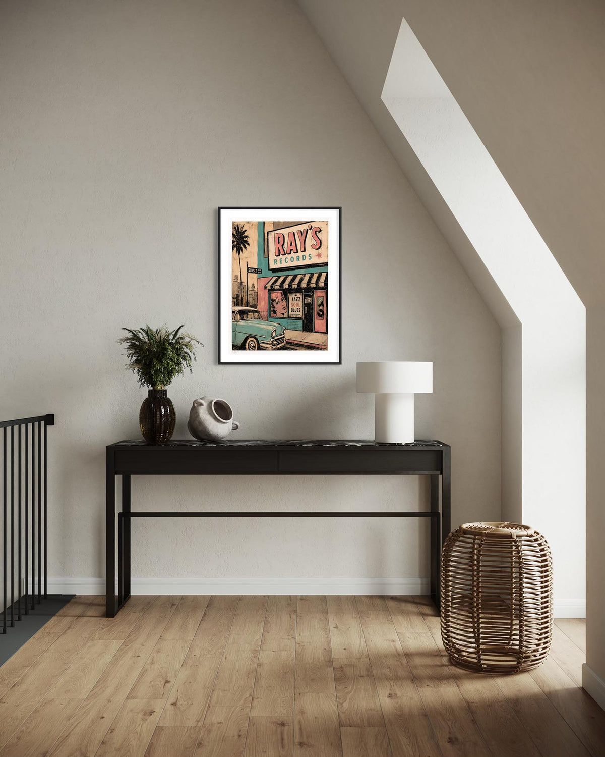 A framed art print featuring a retro-style illustration of 'Ray's Restaurant' hangs on a beige wall above a black console table in a modern, sunlit attic room with wood floors.