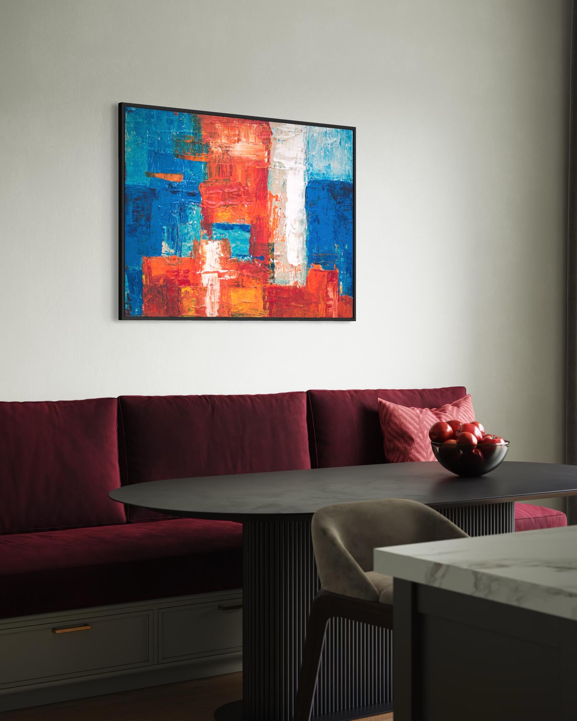Modern interior with a red sofa, round table, and abstract painting on the wall.