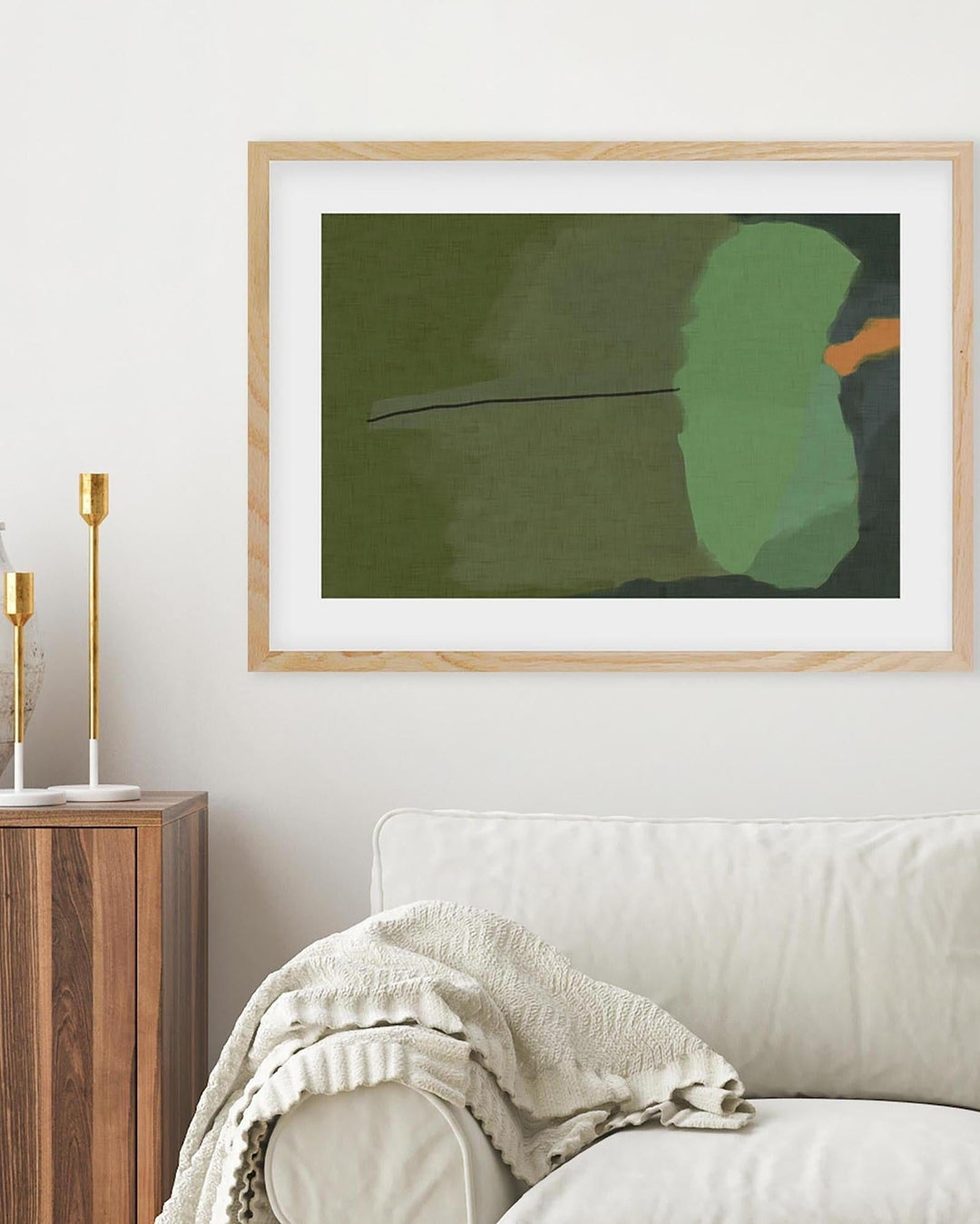 Framed abstract art piece on a wall above a sofa