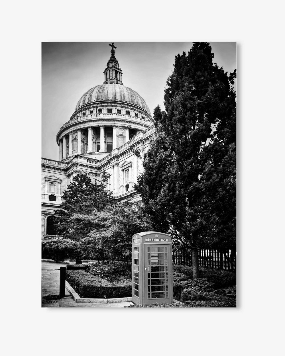 Black and white photo of St. Paul's Cathedral with a telephone booth in the foreground.