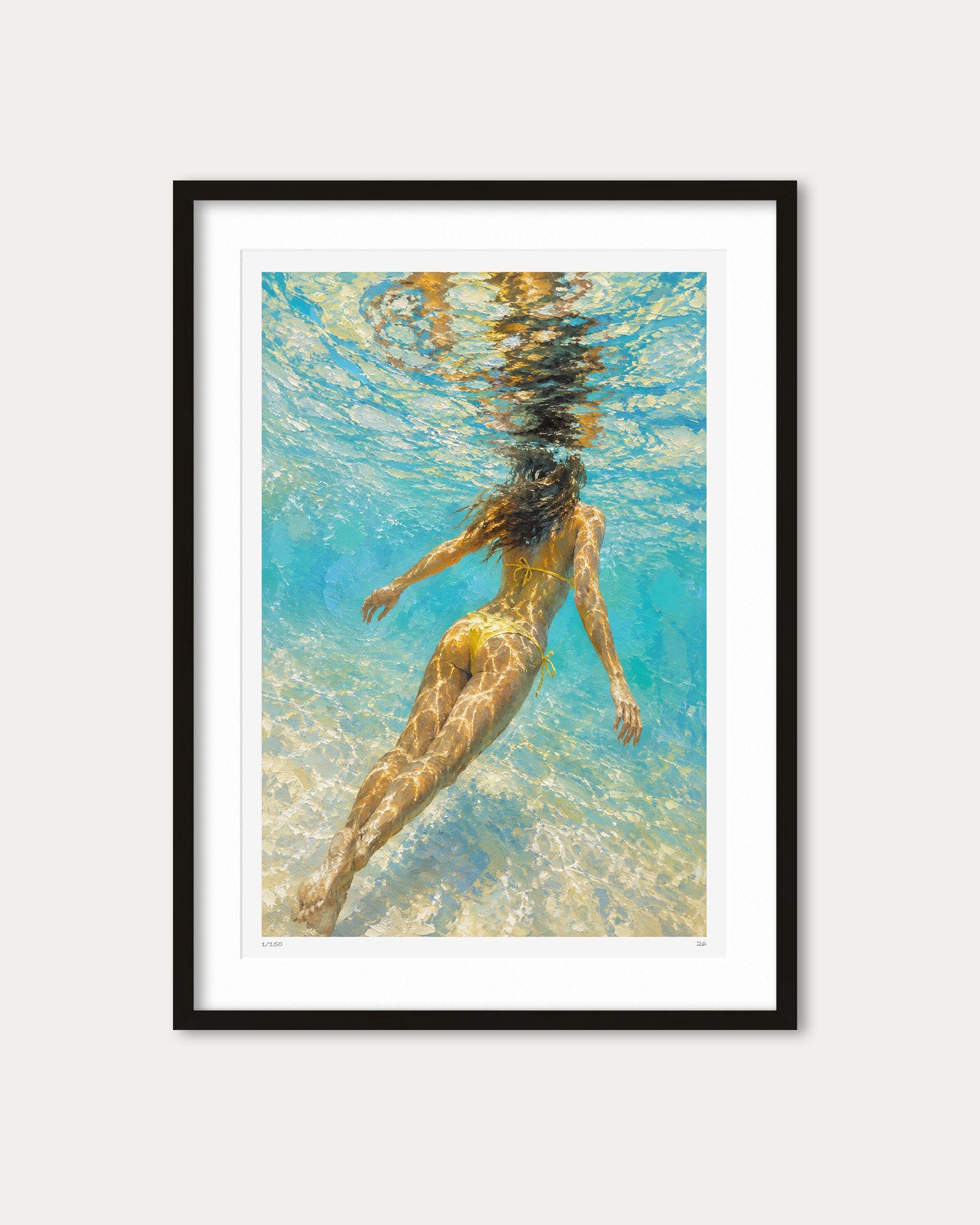 Framed wall art featuring an underwater photograph of a woman swimming in clear turquoise water, presented in a black frame with a white mat against a light gray background.