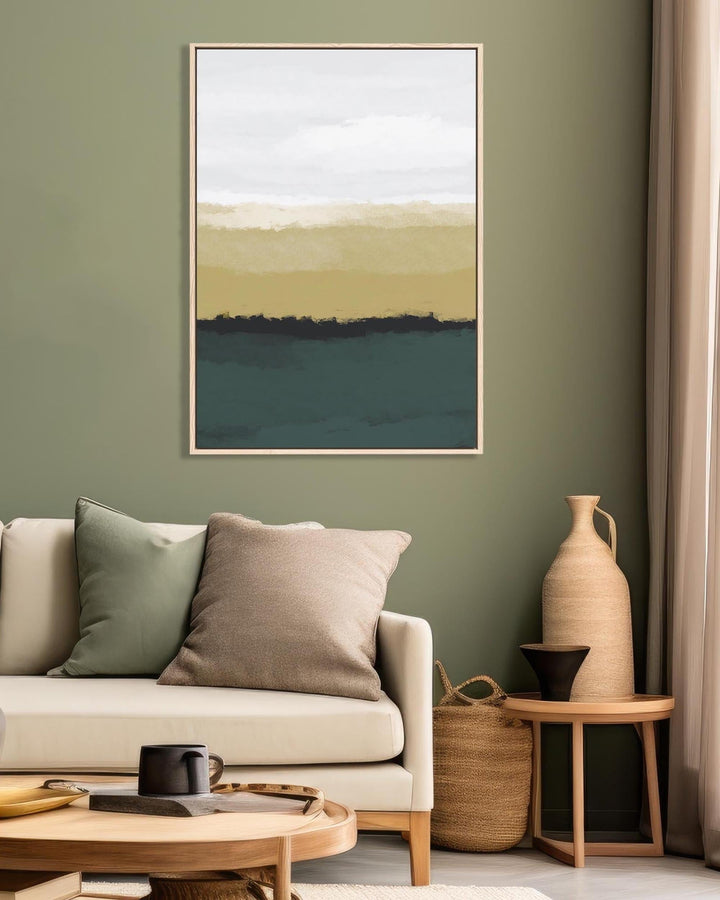 Living room with a beige sofa, abstract art on the wall, and decorative items.