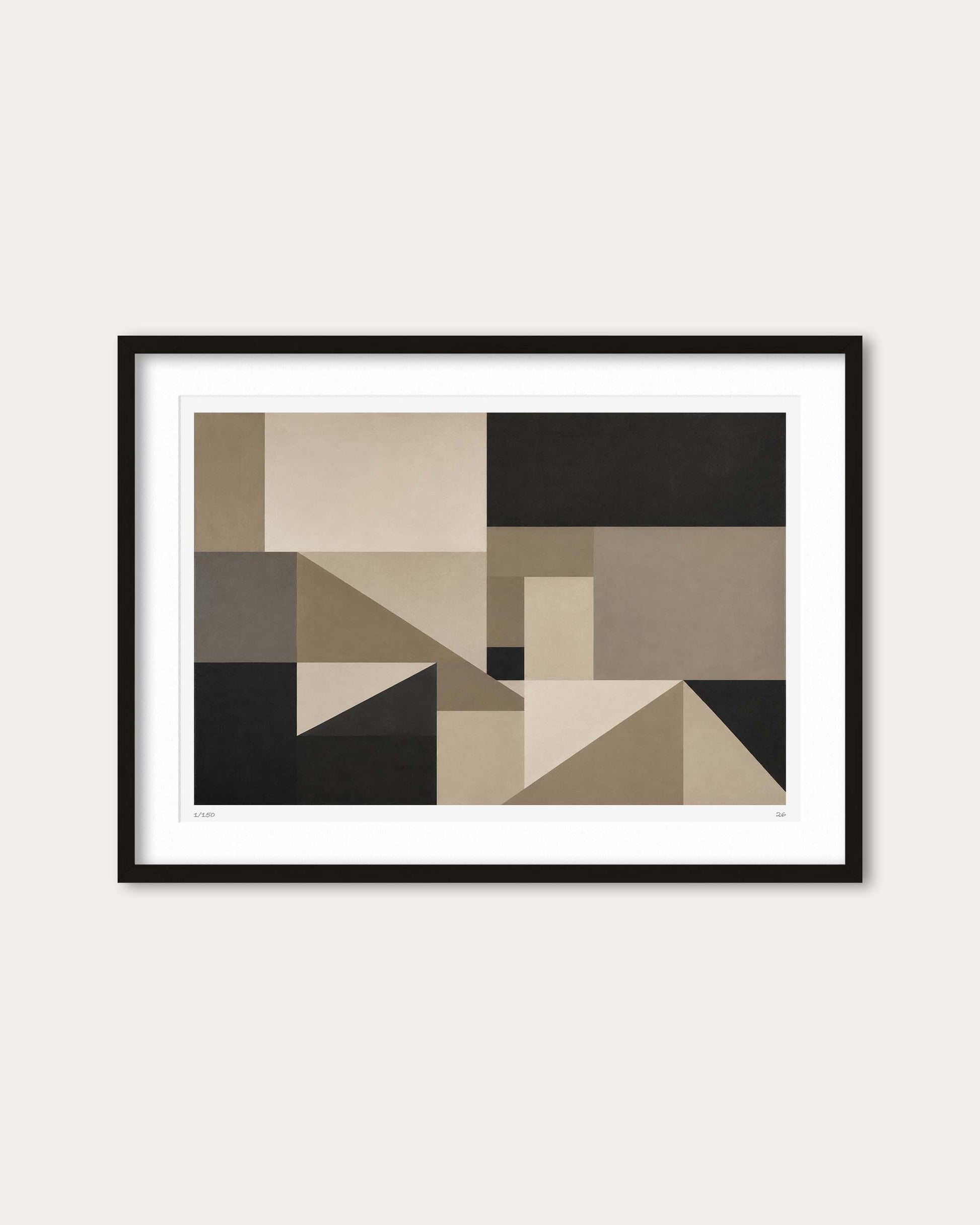 Framed abstract geometric wall art featuring blocks of beige, taupe, black, and gray, presented in a black frame with a white mat against a light beige wall.