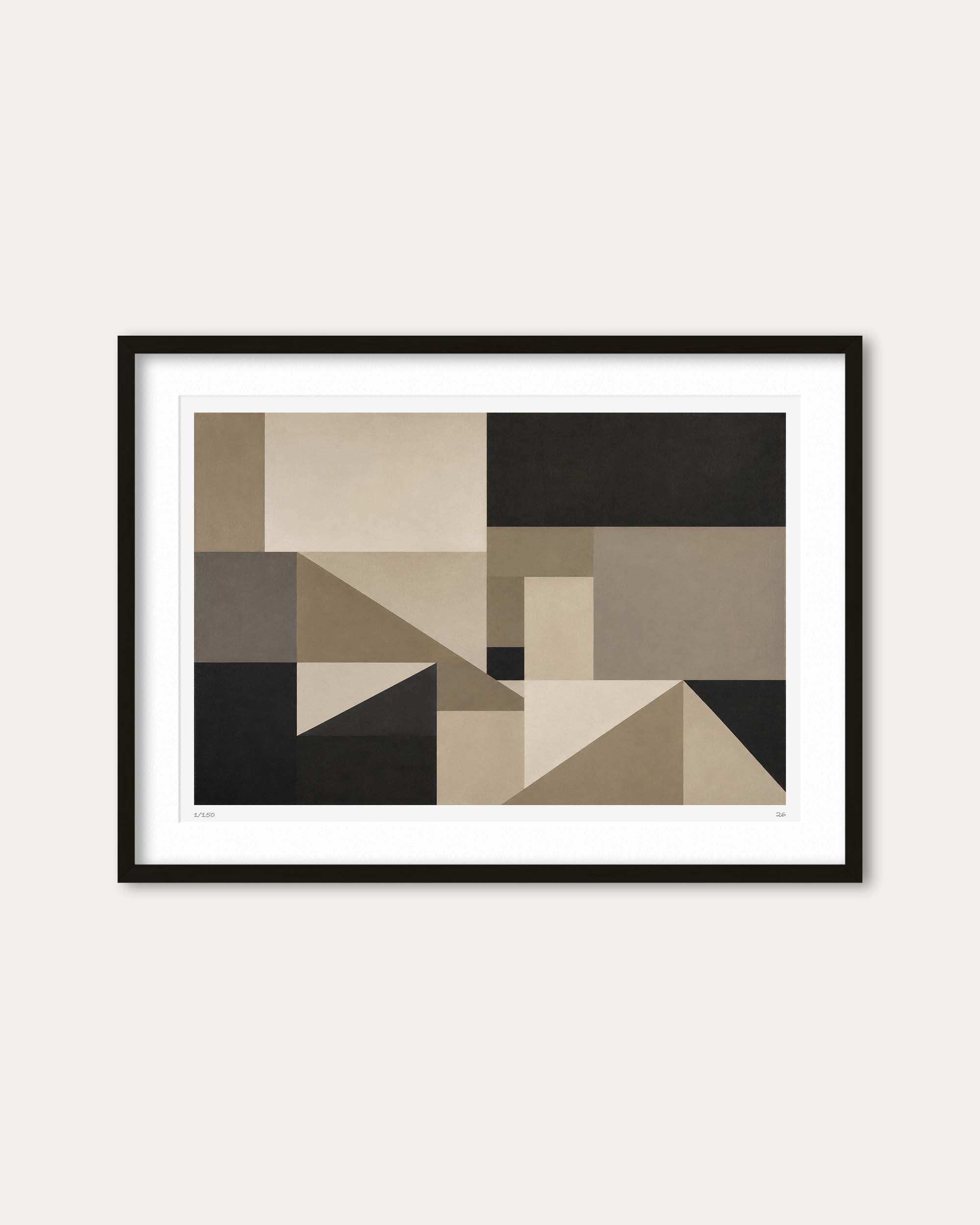 Framed abstract geometric wall art featuring blocks of beige, taupe, black, and gray, presented in a black frame with a white mat against a light beige wall.