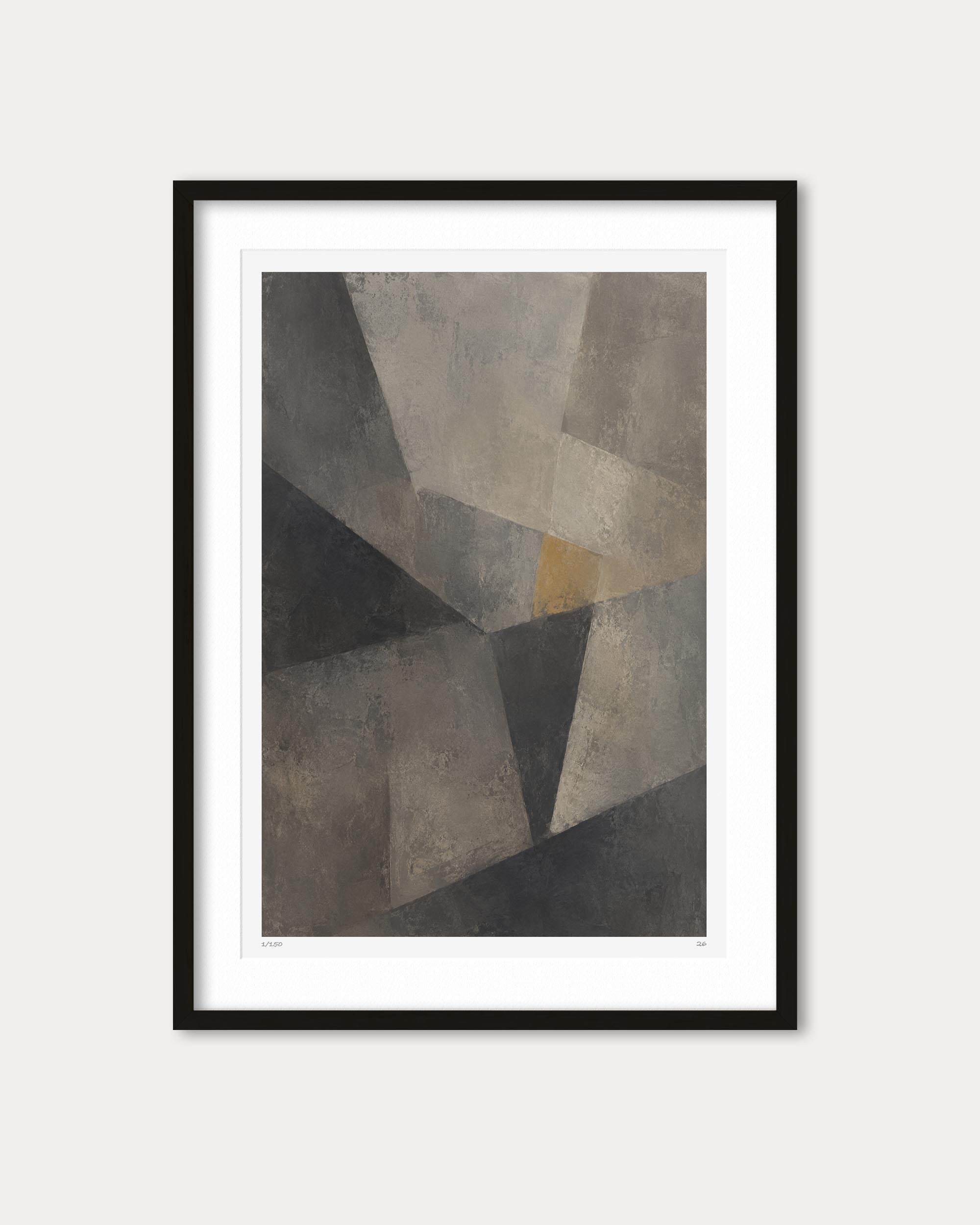 Framed abstract geometric wall art featuring overlapping polygon shapes in gray, taupe, charcoal, and a small muted mustard accent, shown with a white mat and black frame against a light neutral background.