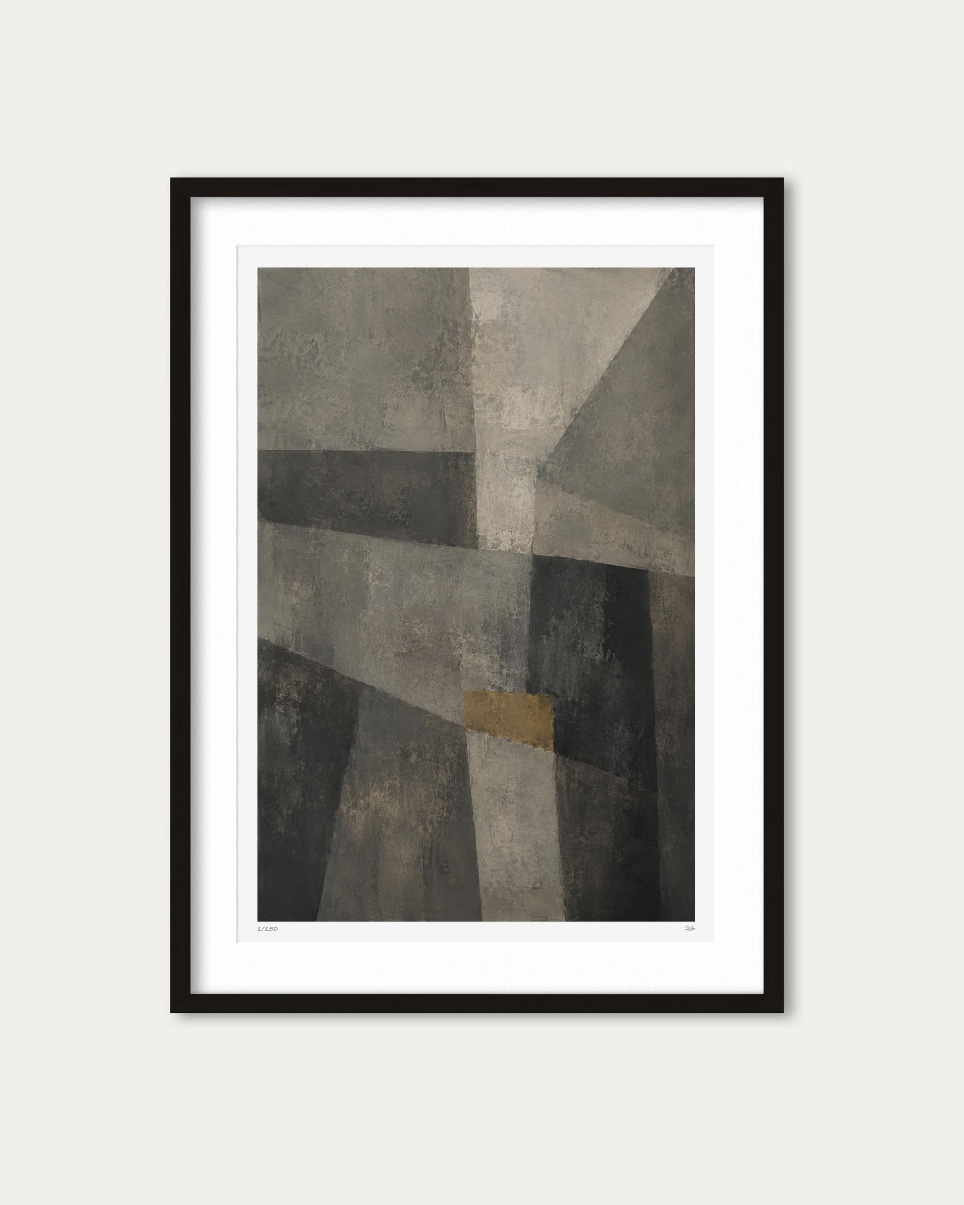 A framed abstract geometric art print with textured gray, black, and beige shapes and a small muted gold square, shown in a black frame with a white mat against a light gray background.