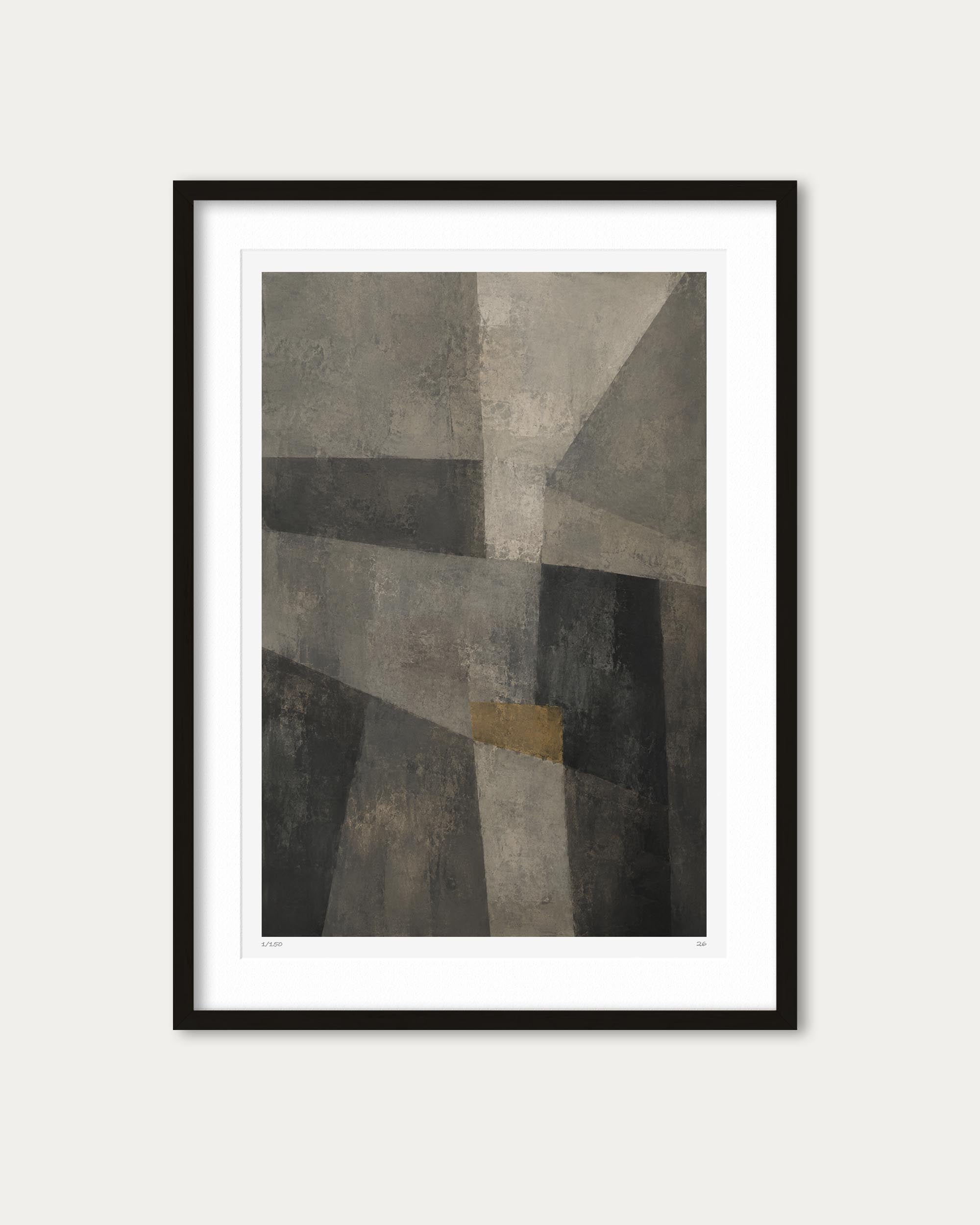 A framed abstract geometric art print with textured gray, black, and beige shapes and a small muted gold square, shown in a black frame with a white mat against a light gray background.
