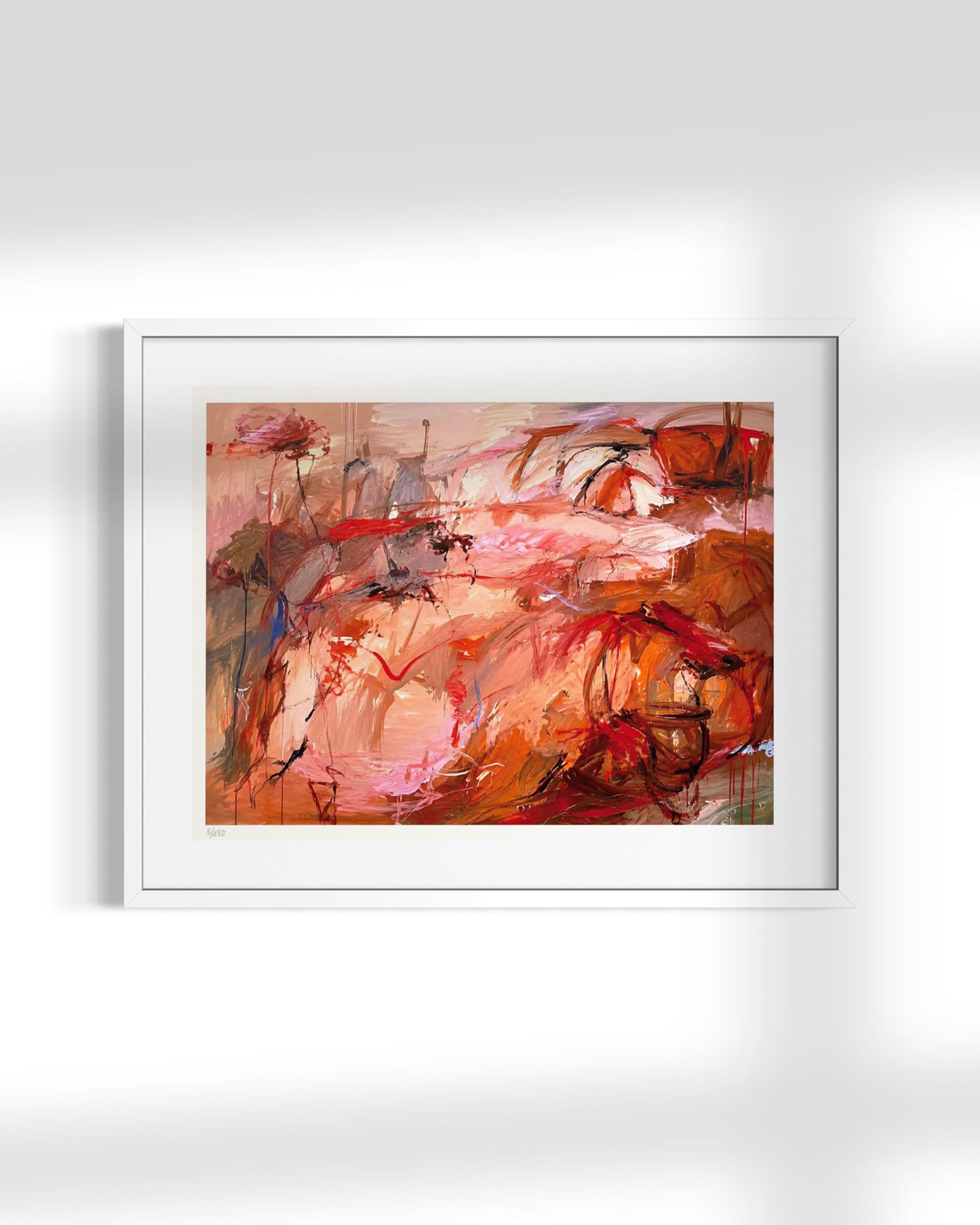 A framed abstract art print featuring expressive brushstrokes in warm tones of red, orange, pink, and brown, displayed on a light gray wall.