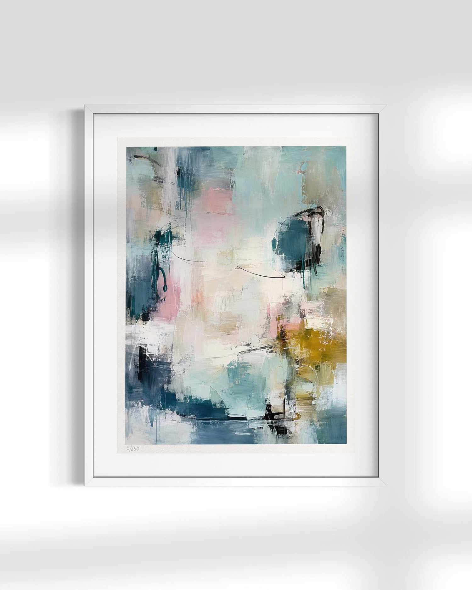 A framed abstract art print featuring a modern composition of blue, teal, pink, white, and gold brushstrokes, presented in a white frame against a light gray wall.