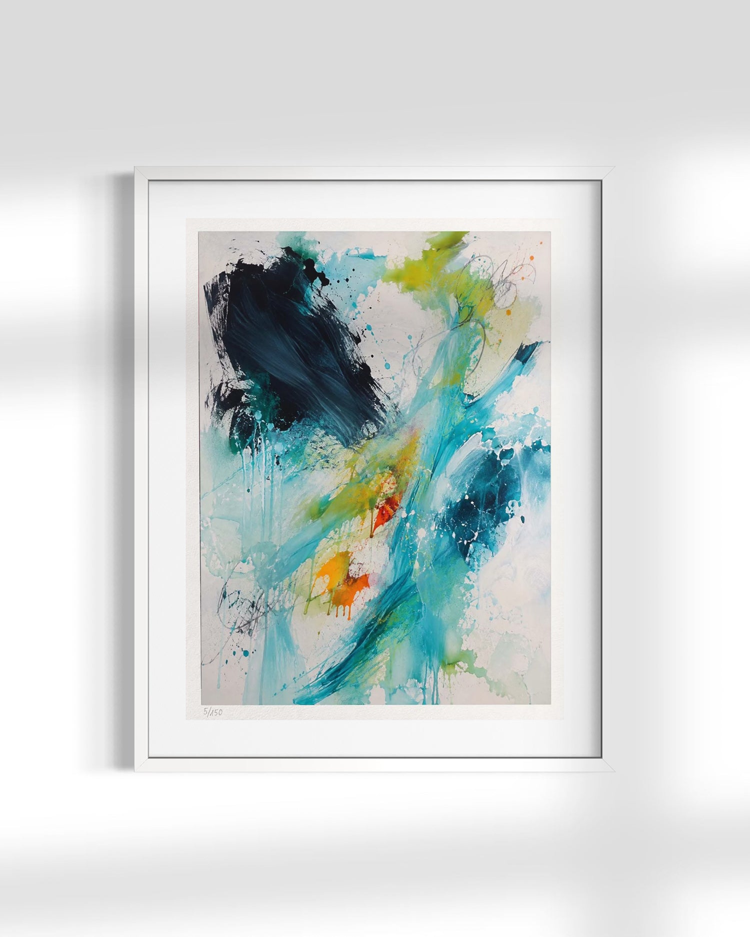 A framed abstract art print featuring expressive brushstrokes and splatters in teal, blue, green, black, and orange on a white mat and white frame, displayed against a light gray wall with soft shadows.