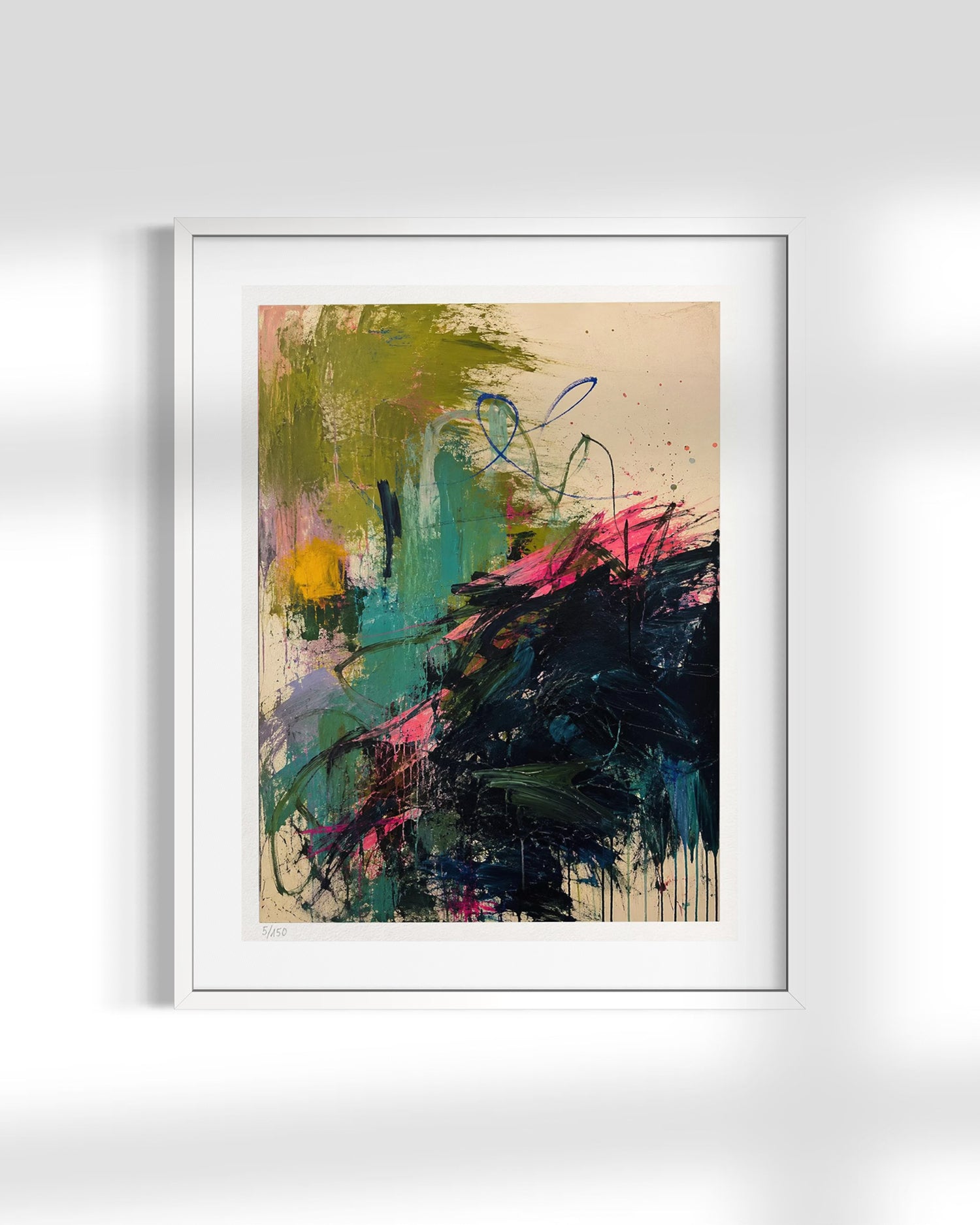 A framed abstract art print featuring expressive brushstrokes in green, teal, black, pink, and yellow on a beige background, presented in a white frame against a light gray wall.