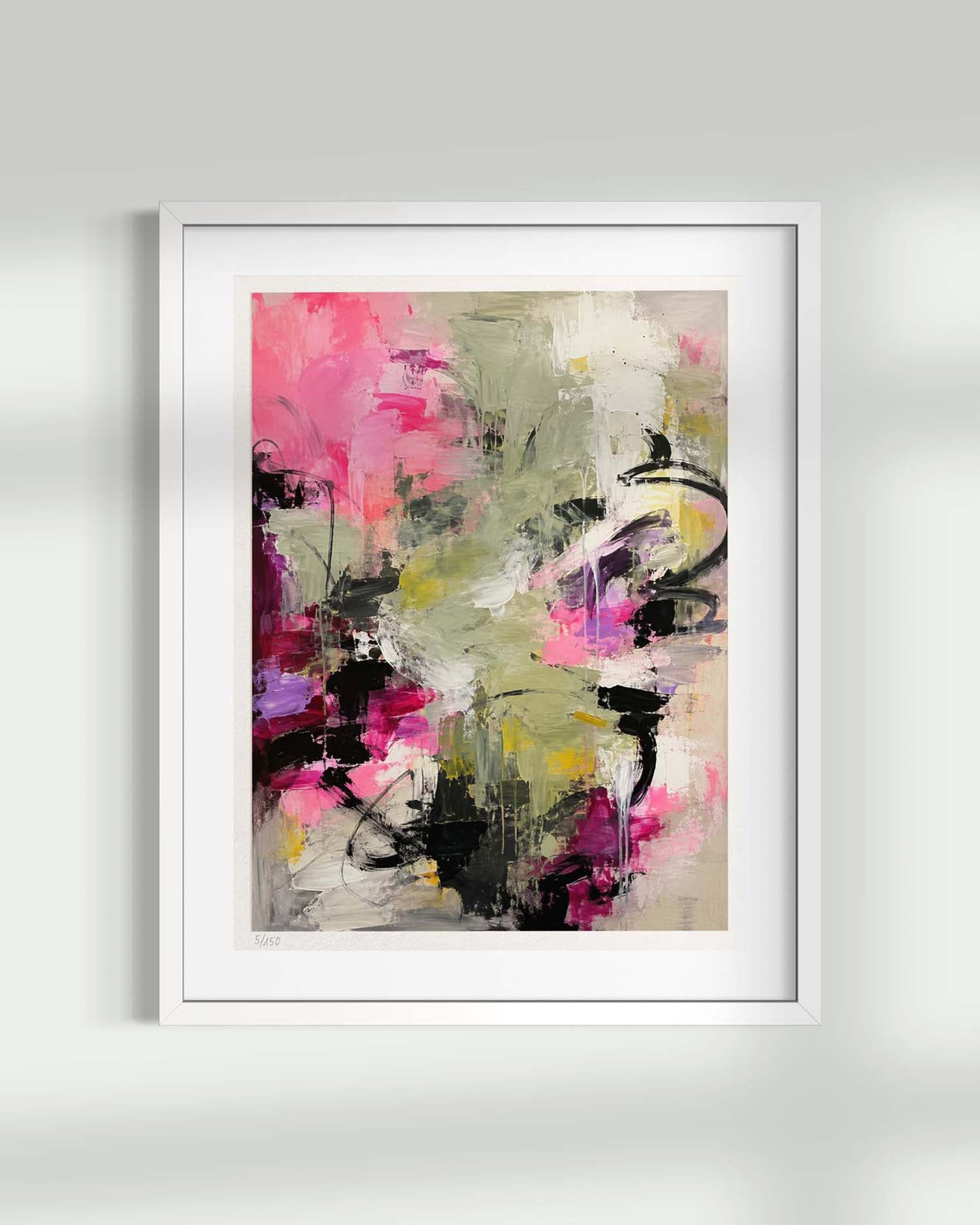 Framed abstract wall art hanging on a light gray wall. The artwork features expressive brushstrokes in pink, olive green, beige, black, and touches of yellow and purple, enclosed in a white frame with a white mat.