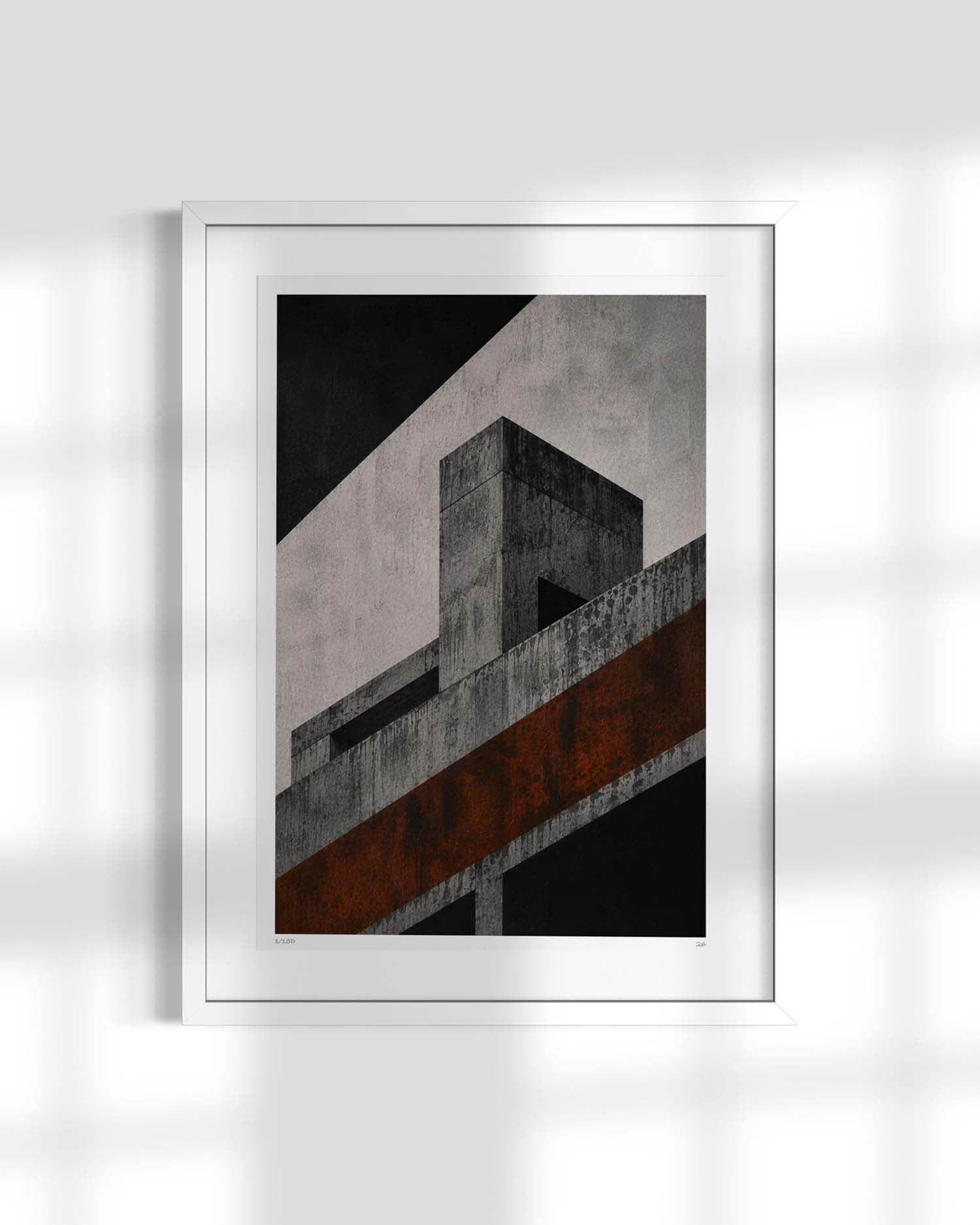 A framed abstract architectural art print featuring a modernist concrete structure in black, gray, and rust-brown tones, presented in a white frame against a light gray wall with soft window shadow patterns.