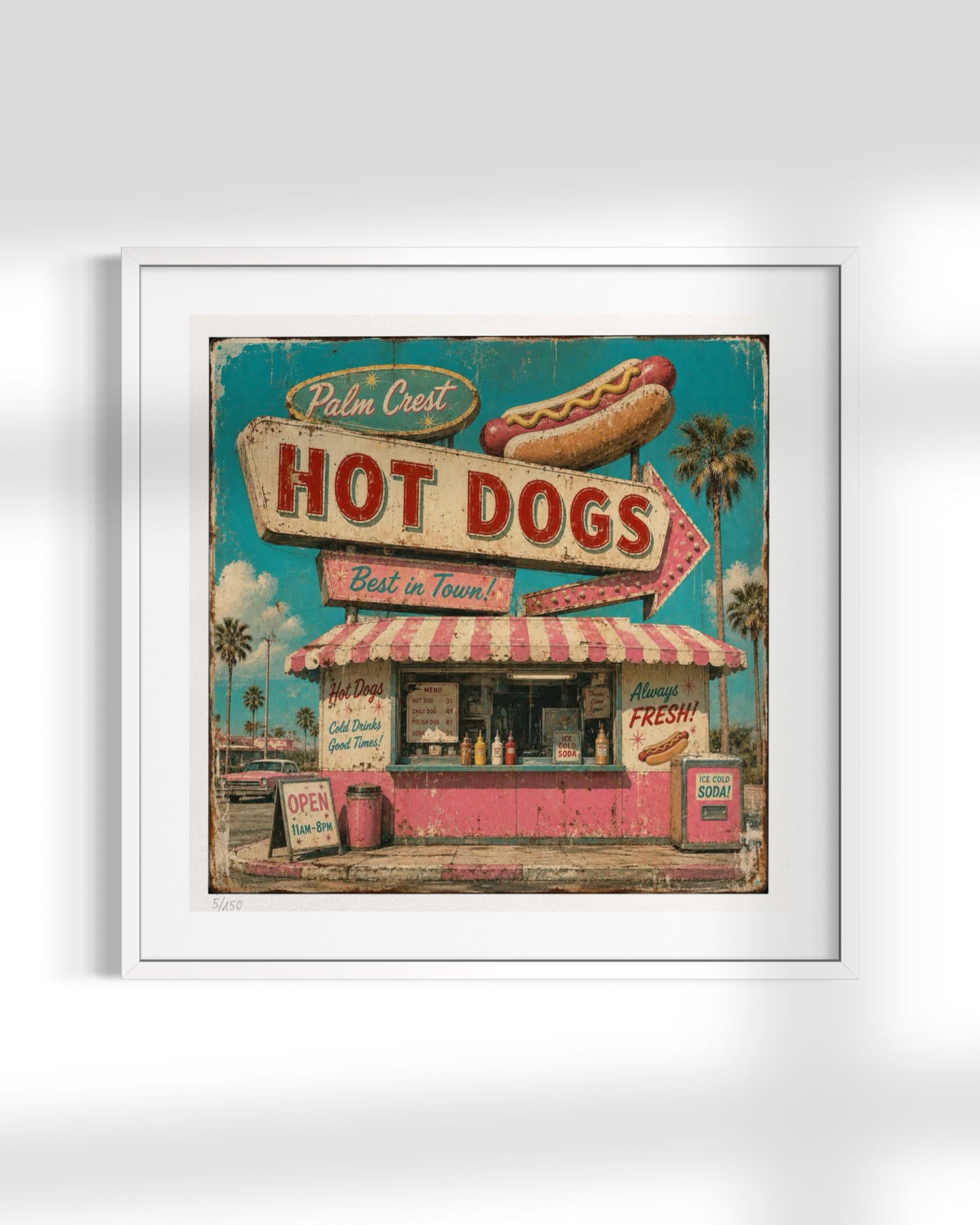 A framed vintage-style art print depicting a retro hot dog stand with a large sign reading 'Palm Crest Hot Dogs,' a hot dog illustration above, and a pink-and-white striped awning, shown against a light gray background.