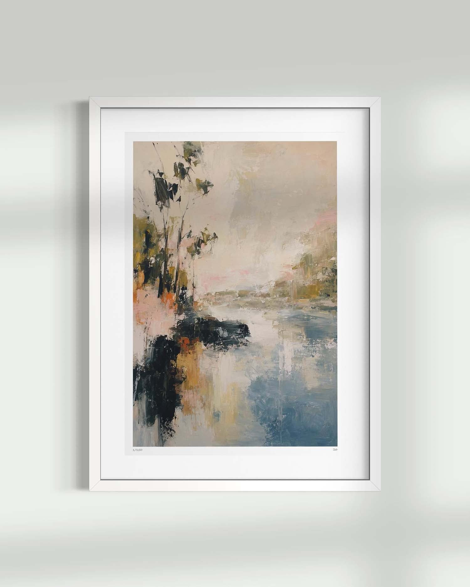 A framed abstract landscape art print featuring blue water, dark tree silhouettes, and soft beige and pink sky tones, displayed in a white frame against a light gray wall.