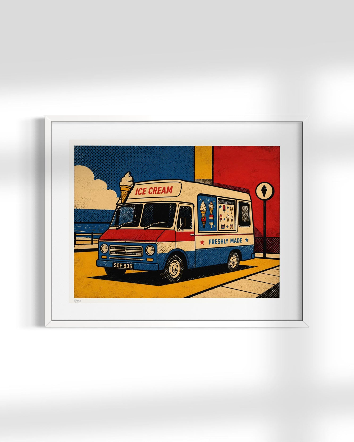A framed pop-art style print of a vintage ice cream truck, shown hanging on a light gray wall. The artwork features a cream, red, and blue truck with a yellow street scene, blue sky, and bold graphic blocks.