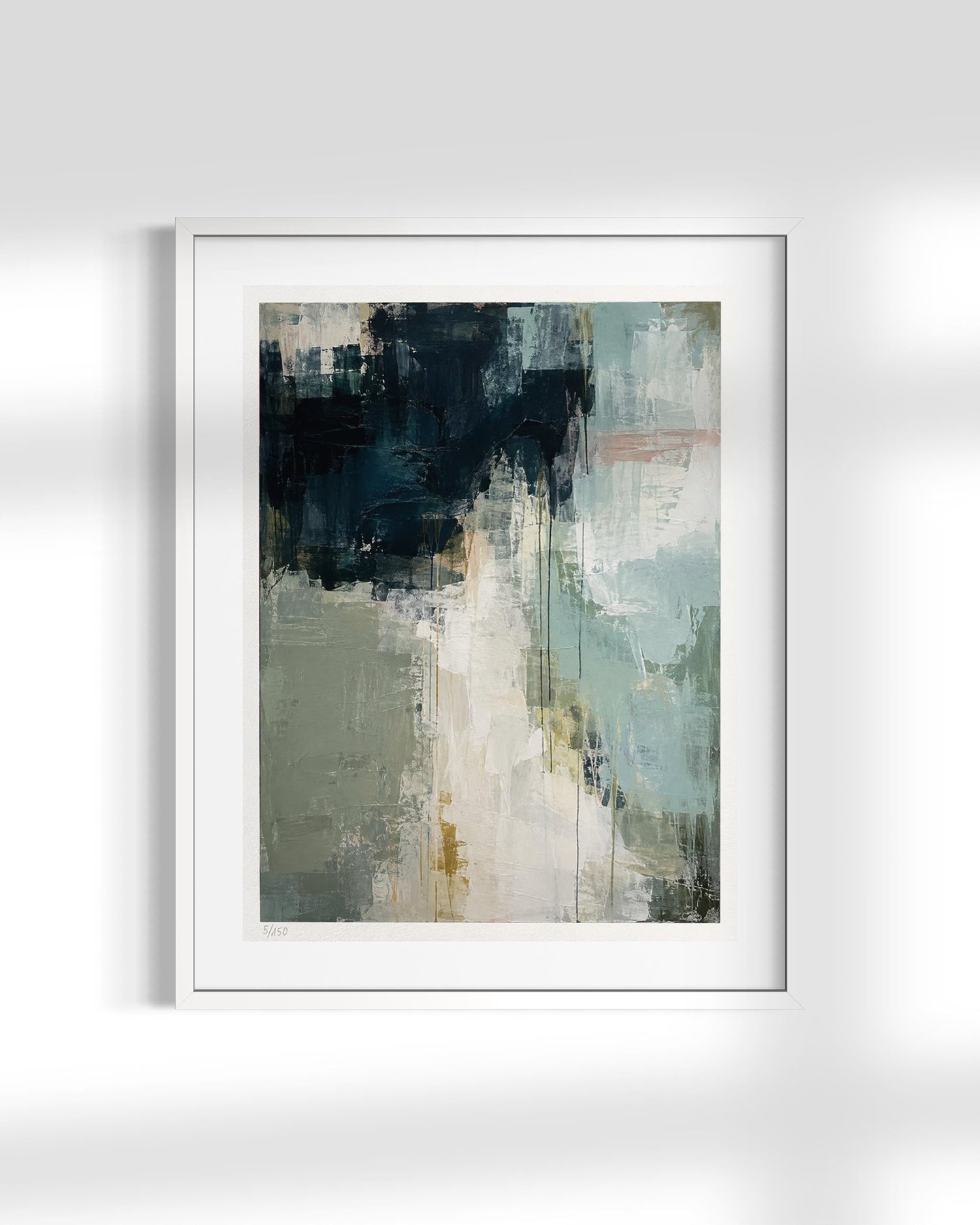 A framed abstract art print featuring textured brushstrokes in navy, sage green, cream, and soft gray, presented in a white frame against a light gray wall with soft shadows.