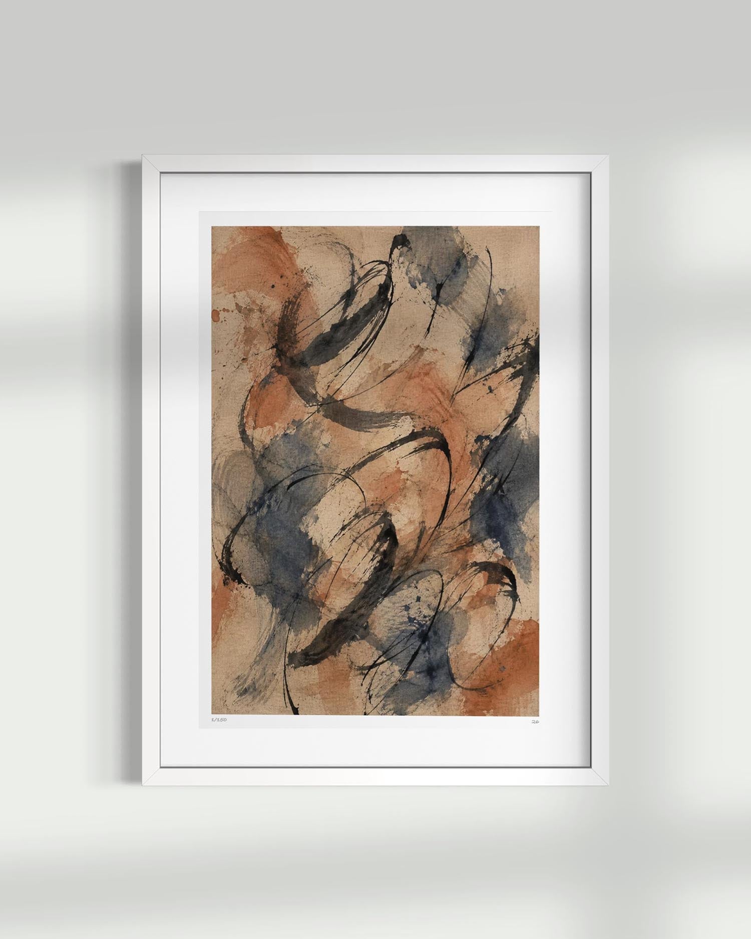 A framed abstract art print featuring expressive black, blue-gray, and terracotta brushstrokes on a warm beige background, presented in a white frame against a light gray wall.